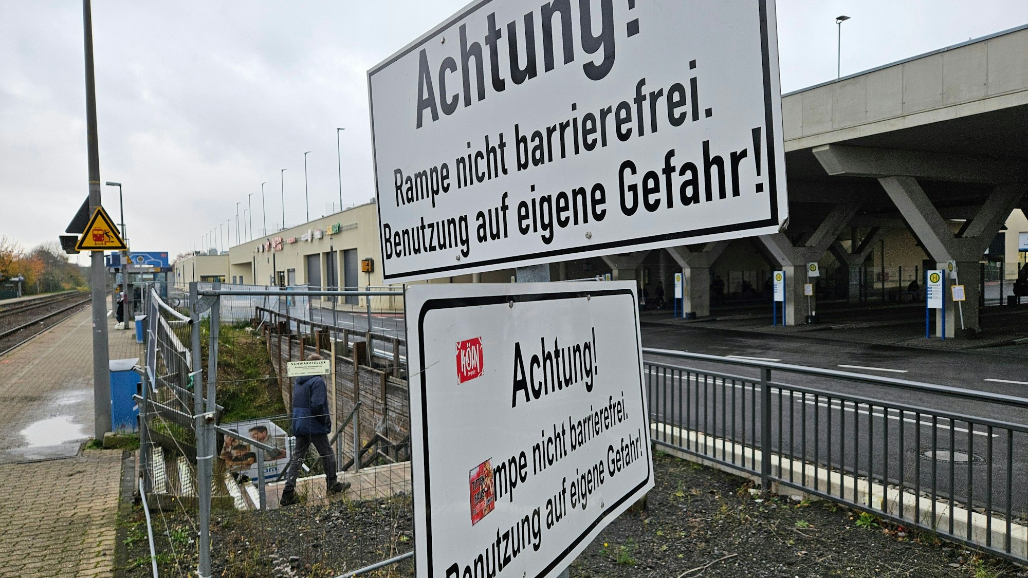 Schilder weisen an einem Bahnsteig darauf hin, dass die Rampe nicht barrierefrei ist.
