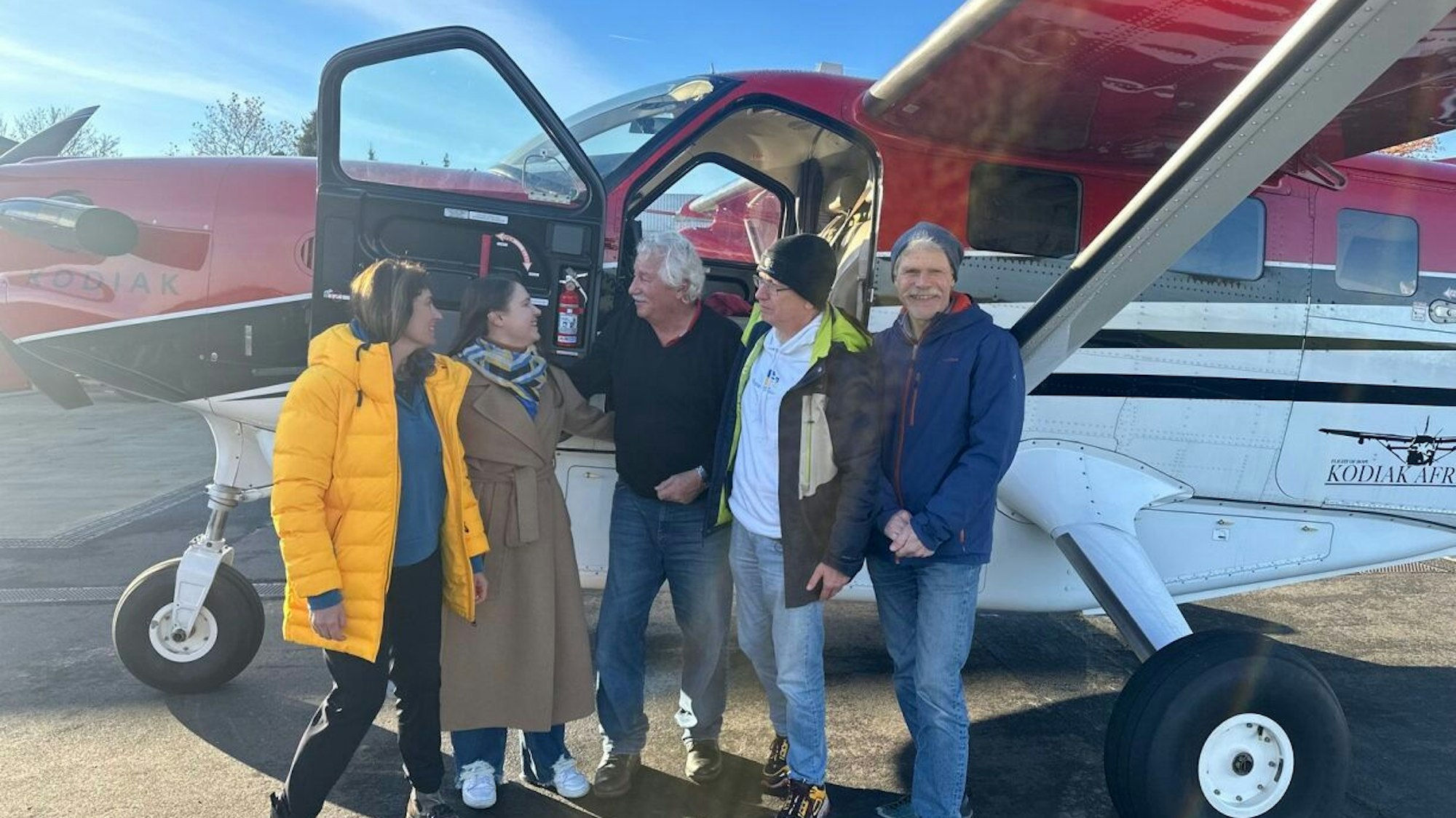 Menschen stehen vor einem Privatflugzeug