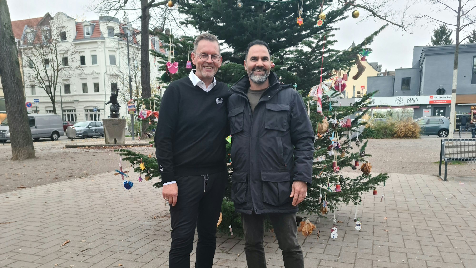 Zwei Leute vor einem Weihnachtsbaum.