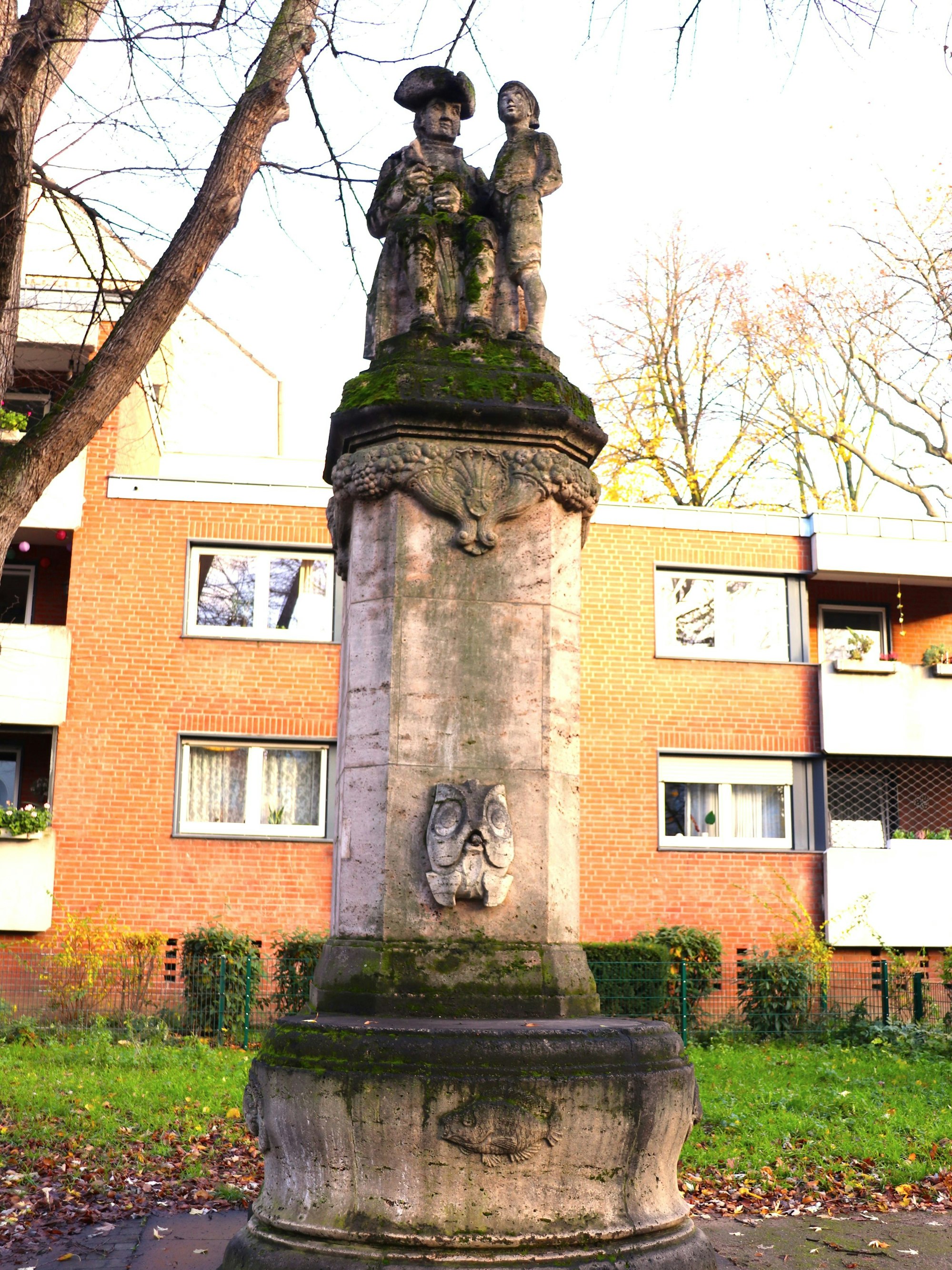 Der Hänneschen-Brunnen mit Pfeiler und Wasserbecken.