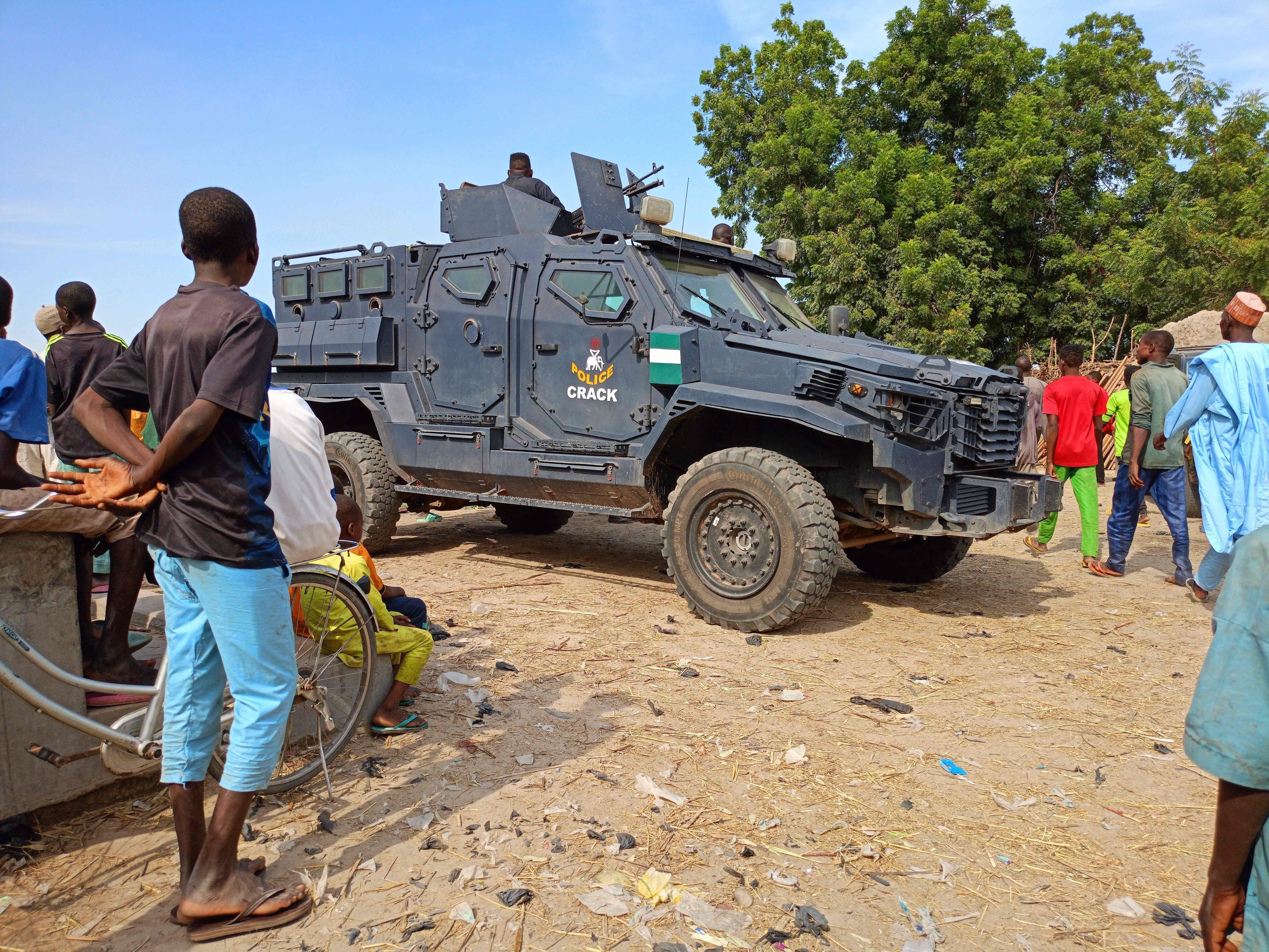 An armoured police vehicle is seen in the Zabarmari district, near Maiduguri, on November 6, 2023, during a burial of farmers that were victims of an attack. Jihadists have killed at least 11 farmers and several others are missing after an attack on rice fields in Nigeria's northeast Borno State, anti-jihadist militia and residents said on November 6, 2023.
Suspected Boko Haram jihadists stormed rice fields in Zabarmari district outside the regional capital Maiduguri late on November 5, 2023, seizing farmers and slitting their throats while abducting others, the sources told AFP.
Farmers are often targeted by Islamist militants waging a 14-year conflict in Nigeria's northeast, where 40,000 people have been killed and more than two million displaced since 2009. (Photo by Audu MARTE / AFP)