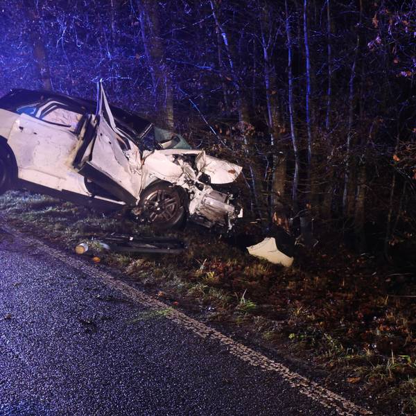 Ein Autowrack im Straßengraben.