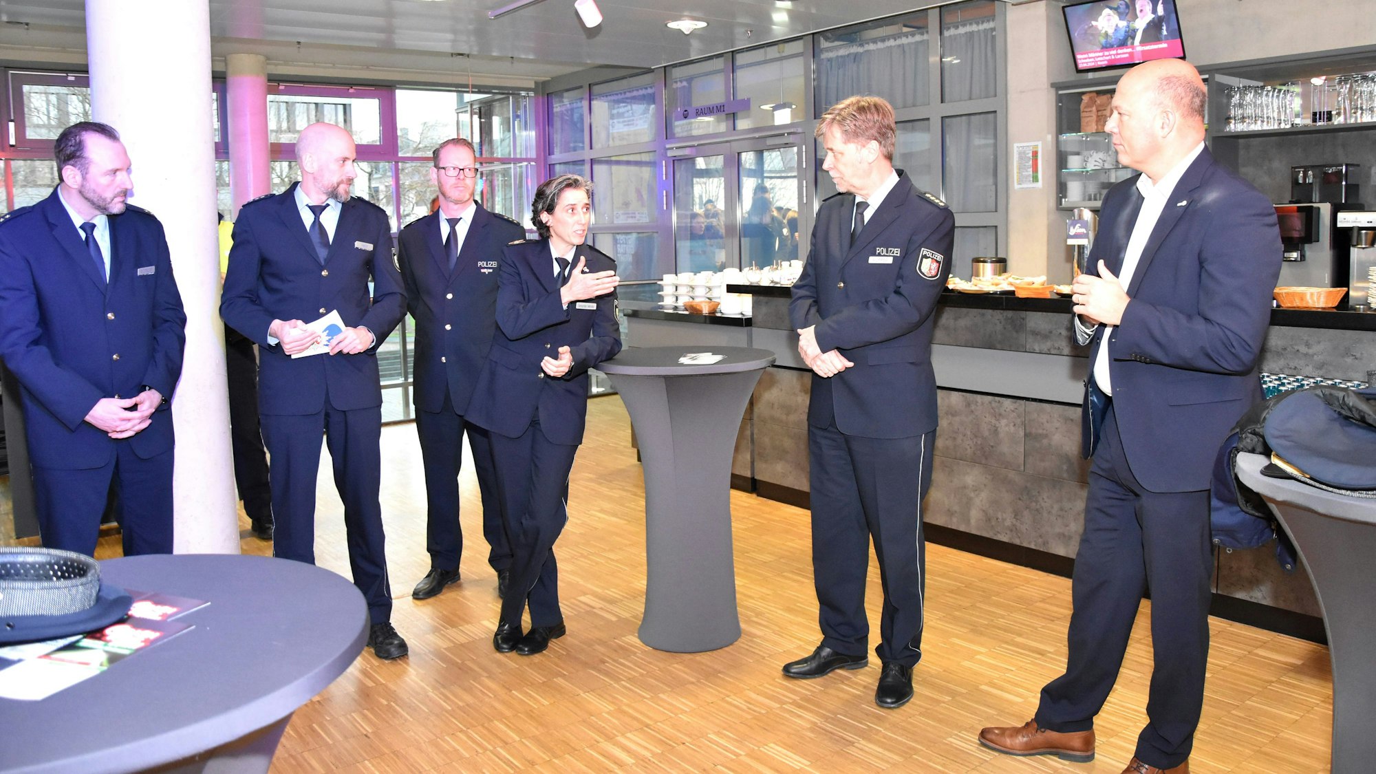 Männer und eine Frau unterhalten sich.