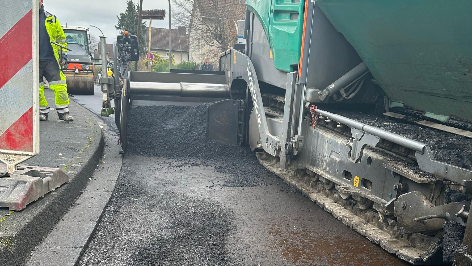 Ein neuer Belag wird auf die Berliner Straße aufgetragen.