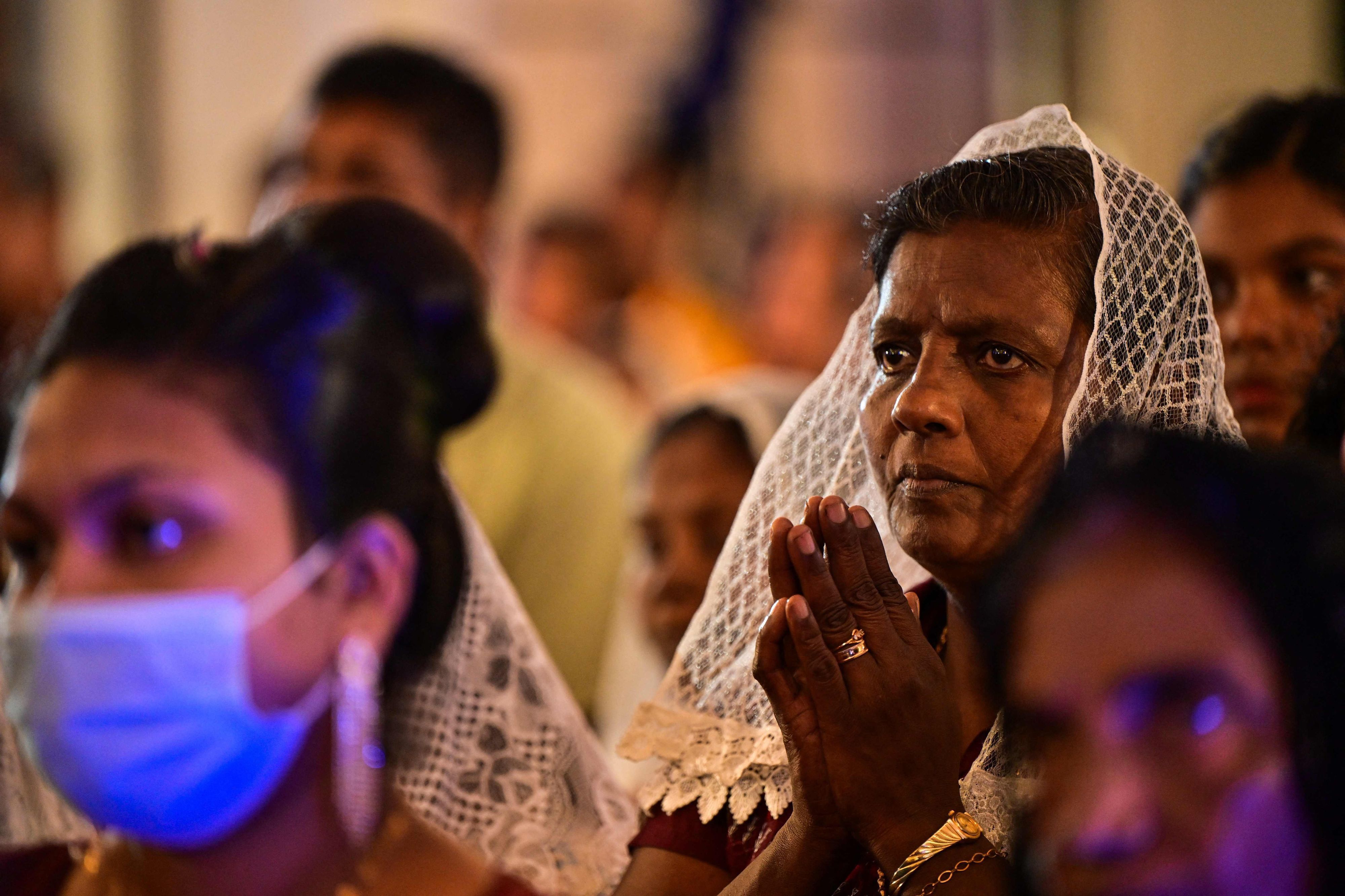 Christians devotees pray during a Christmas mass at the St. Francis Xavier's Church in Halpe on December 25, 2023. (Photo by Ishara S. KODIKARA / AFP)