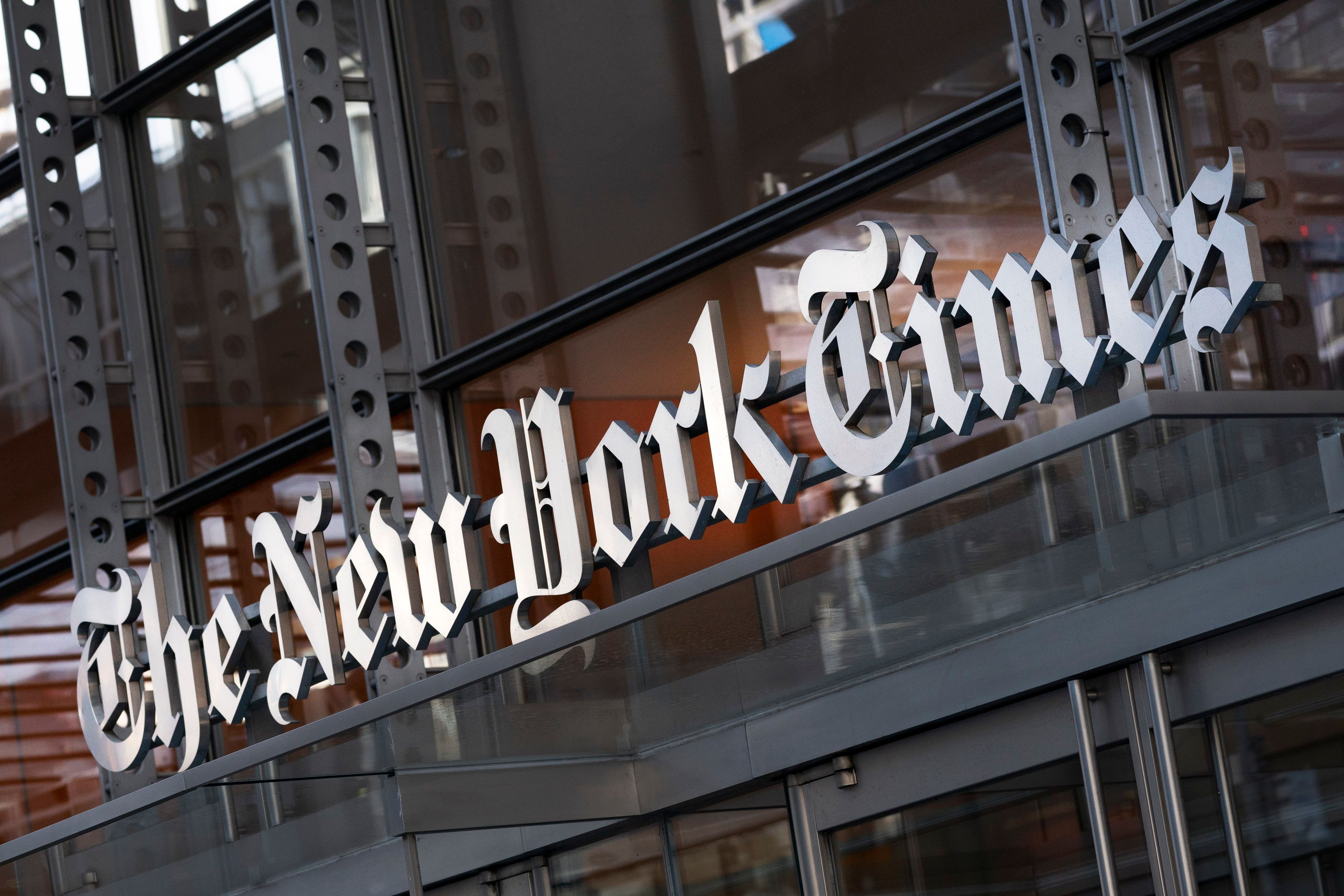 FILE - A sign for The New York Times hangs above the entrance to its building, Thursday, May 6, 2021 in New York.  The New York Times filed a federal lawsuit against OpenAI and Microsoft on Wednesday, Dec. 27, 2023 seeking to end the practice of using published material to train chatbots. (AP Photo/Mark Lennihan, File)