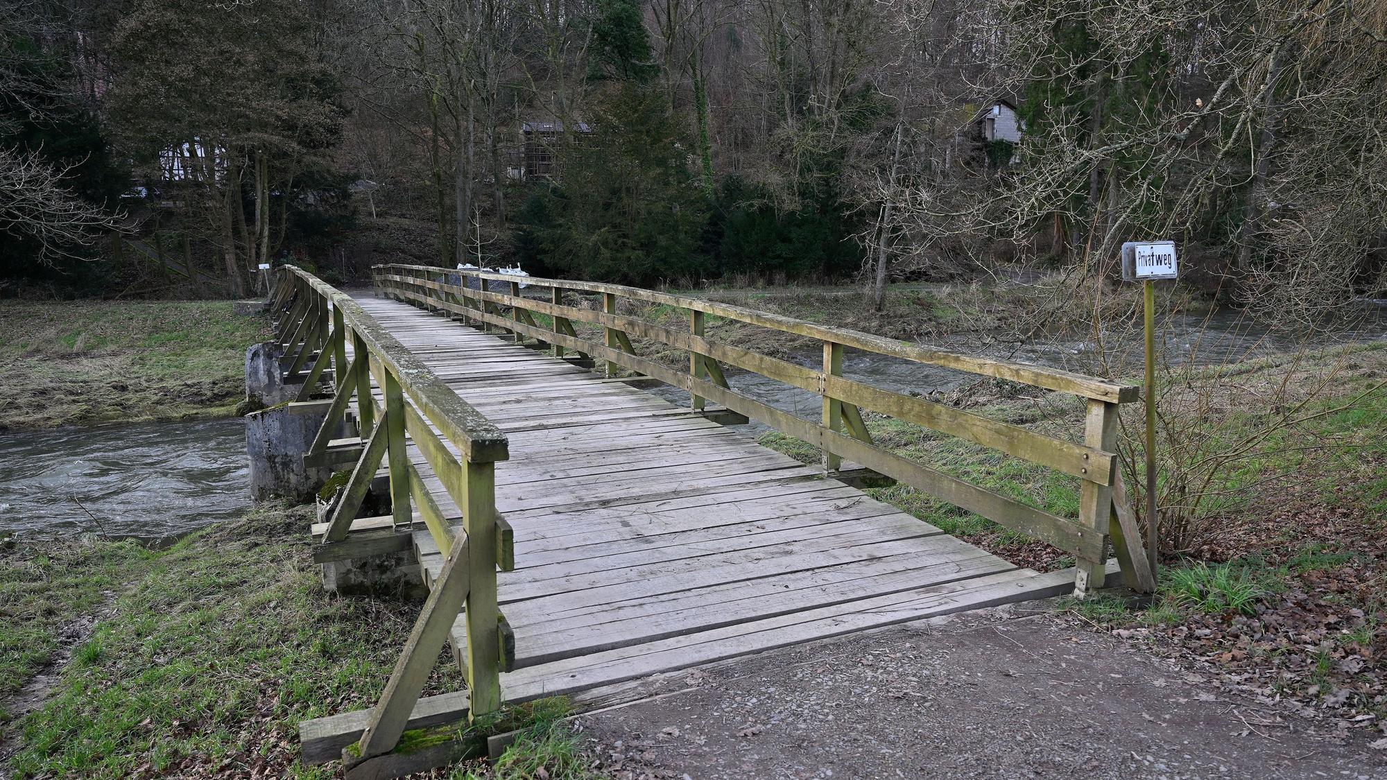 Zu sehen ist die Holzbrücke über die Sülz. Am Ufer rechts und links sind überspülte Wiesen.