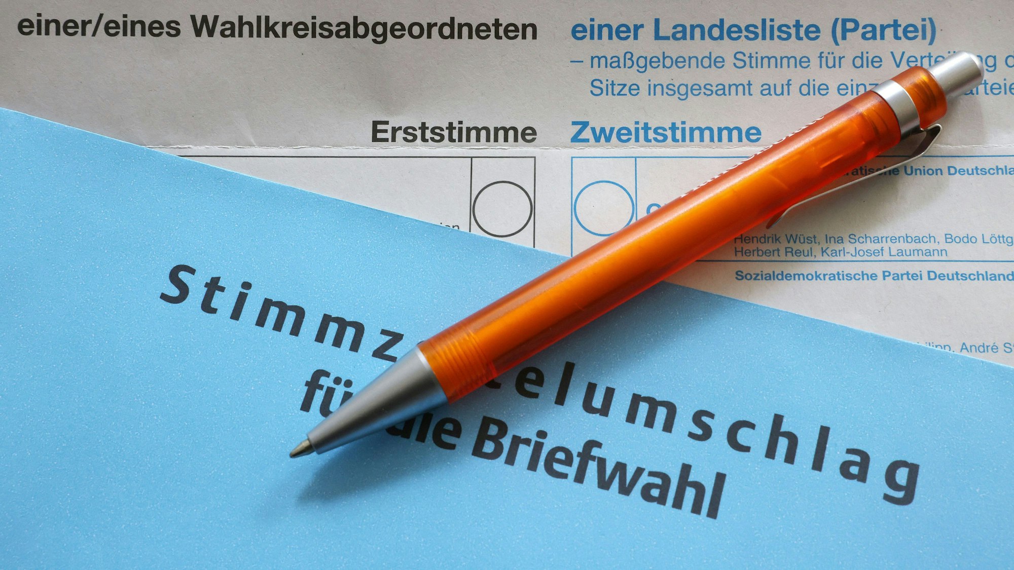 Unterlagen für die Briefwahl liegen auf einem Tisch.