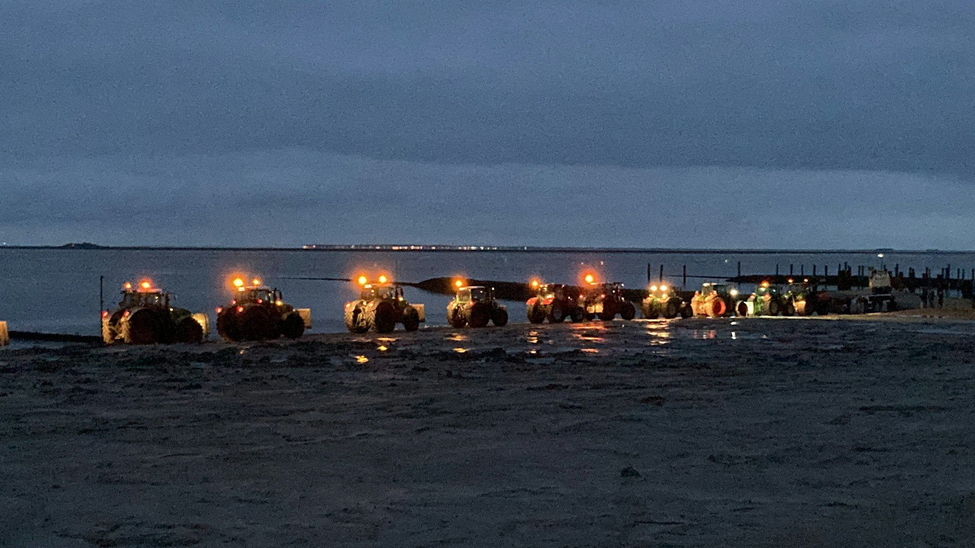 Landwirte mit Traktoren stehen im Umfeld des Fähranlegers. Wütende Bauern hinderten Vizekanzler Robert Habeck (Grüne) in Schlüttsiel in Schleswig-Holstein am Verlassen einer Fähre.