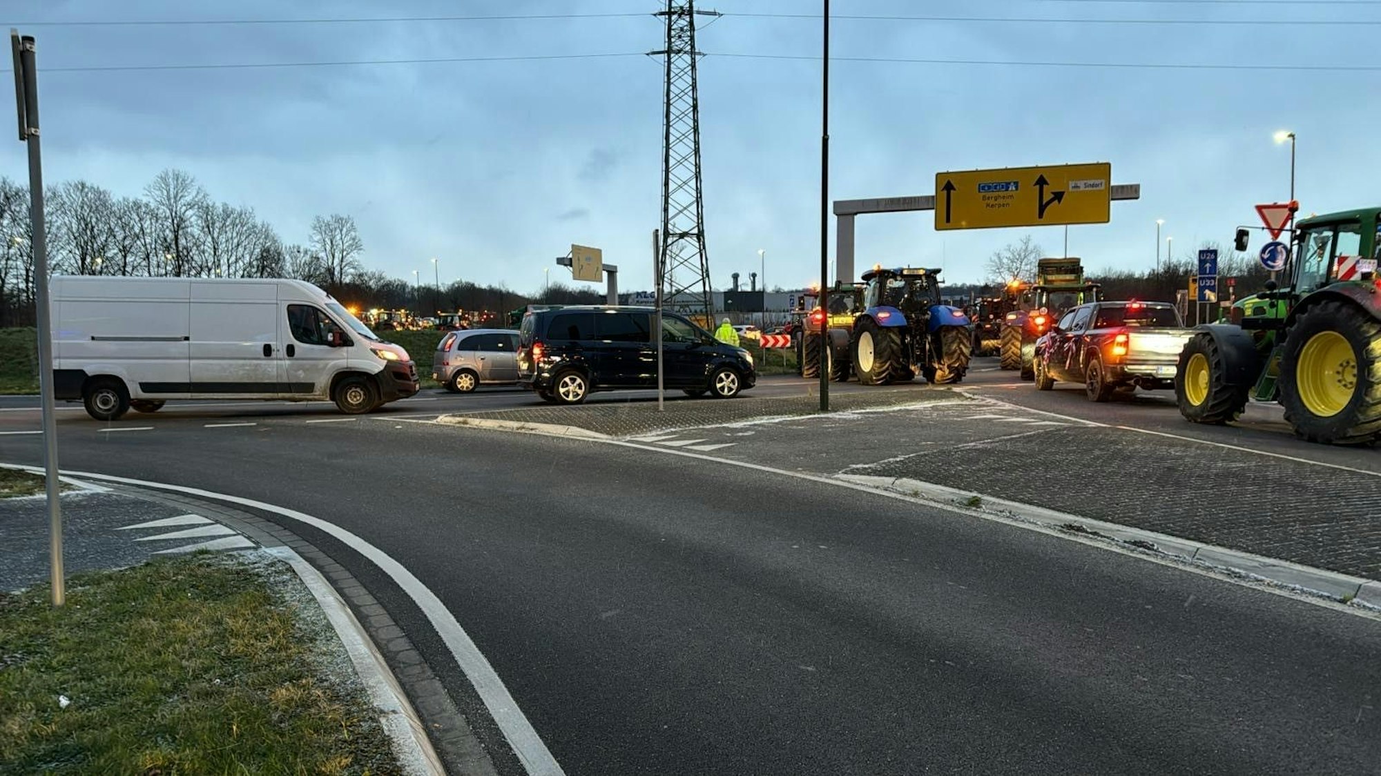 Auf dem Foto ist zu sehen, wie sich Landwirte den Weg zur A4/A61in Kerpen blockieren.