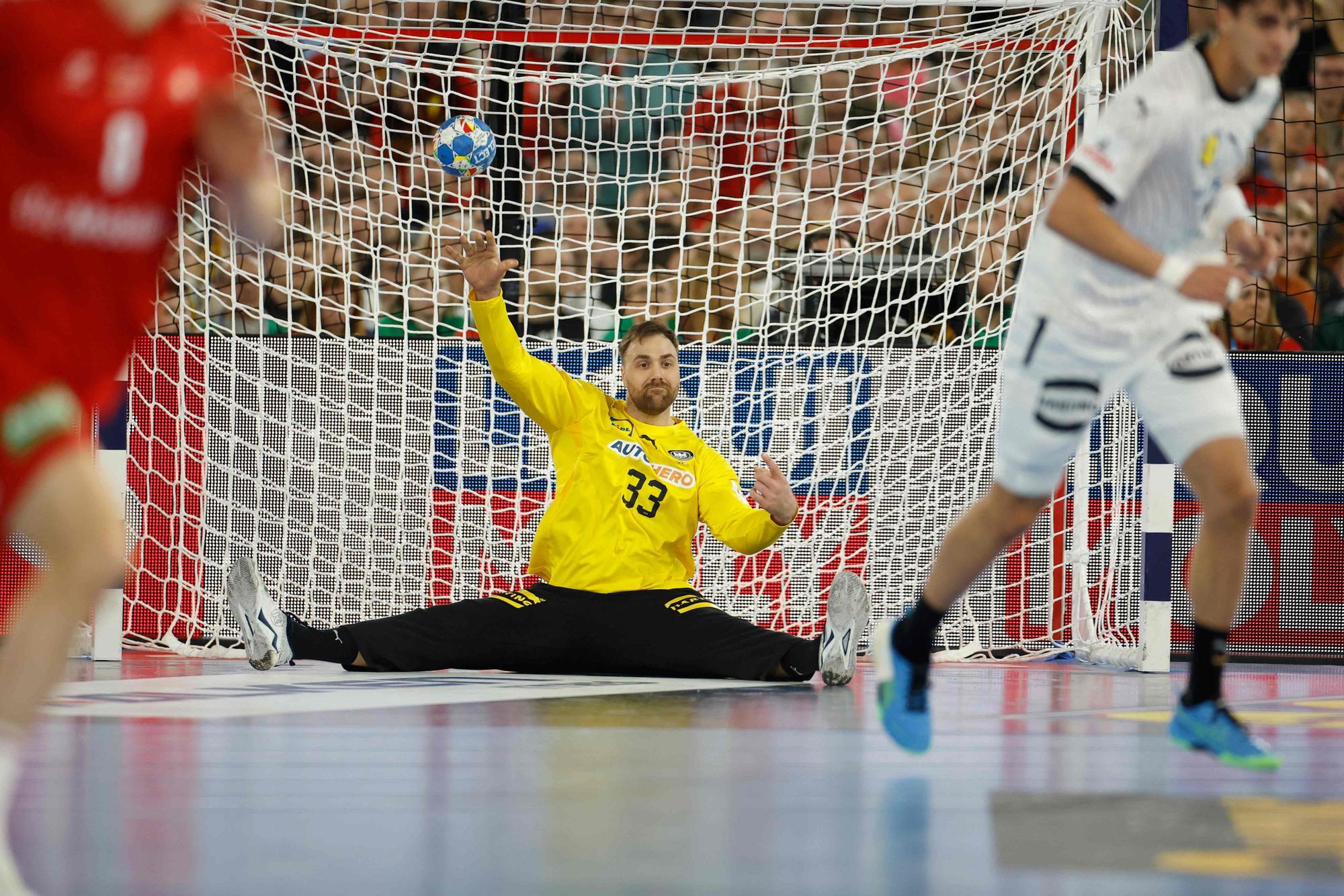 TOPSHOT - Germany's goalkeeper #33 Andreas Wolff aims for the ball while sitting on the ground during the men's EURO 2024 EHF Handball European Championship match Group A between Germany and Switzerland in Dusseldorf, western Germany on January 10, 2024. (Photo by Odd ANDERSEN / AFP)