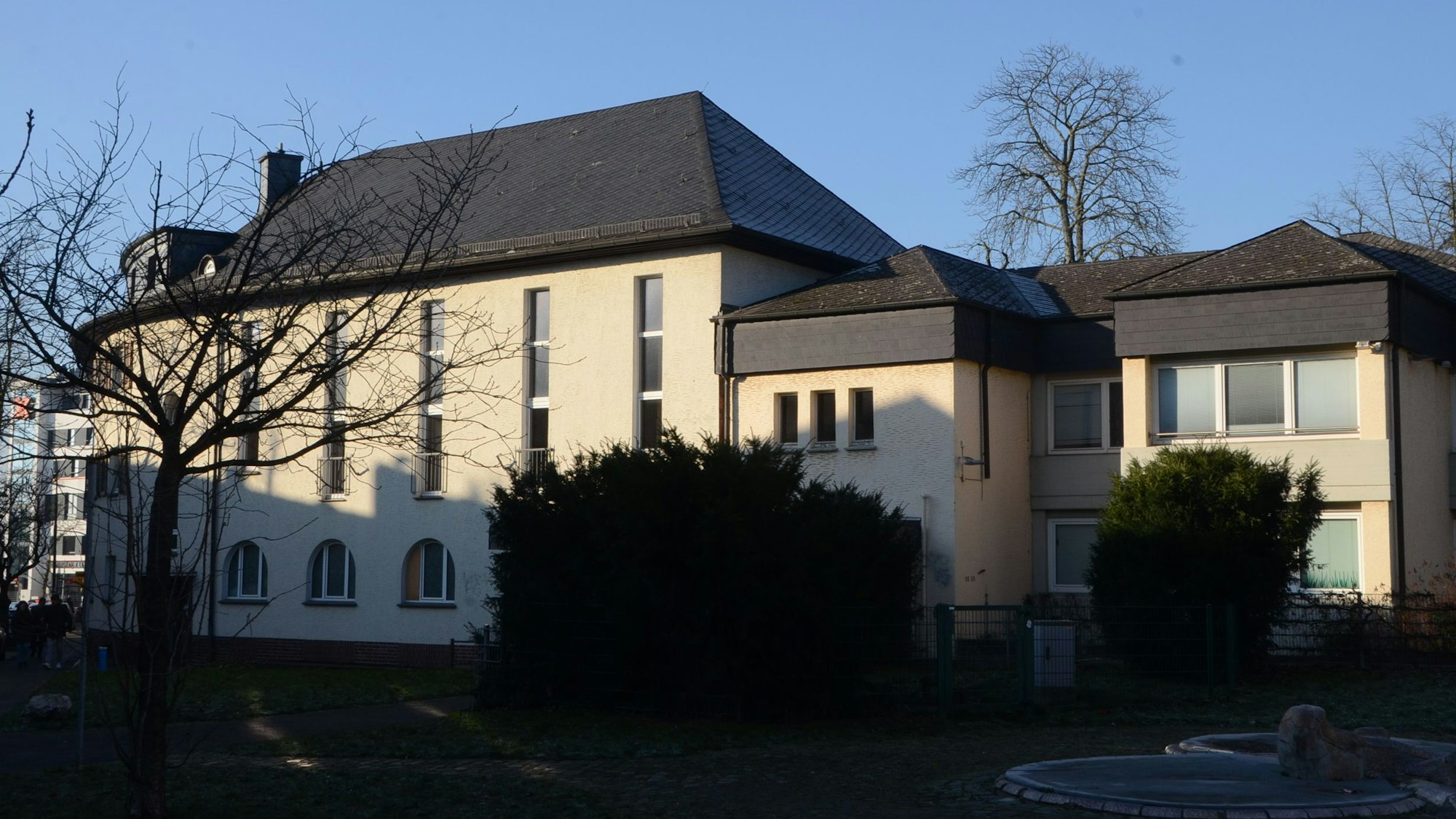 Ein großes Gebäude aus den 1930er Jahren. Rechts steht ein modernerer Anbau aus den 1970er Jahren.