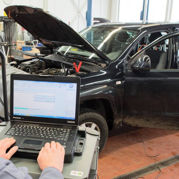 Ein Software-Update für das Steuergerät der Motorelektronik wird an einem Volkswagen installiert.