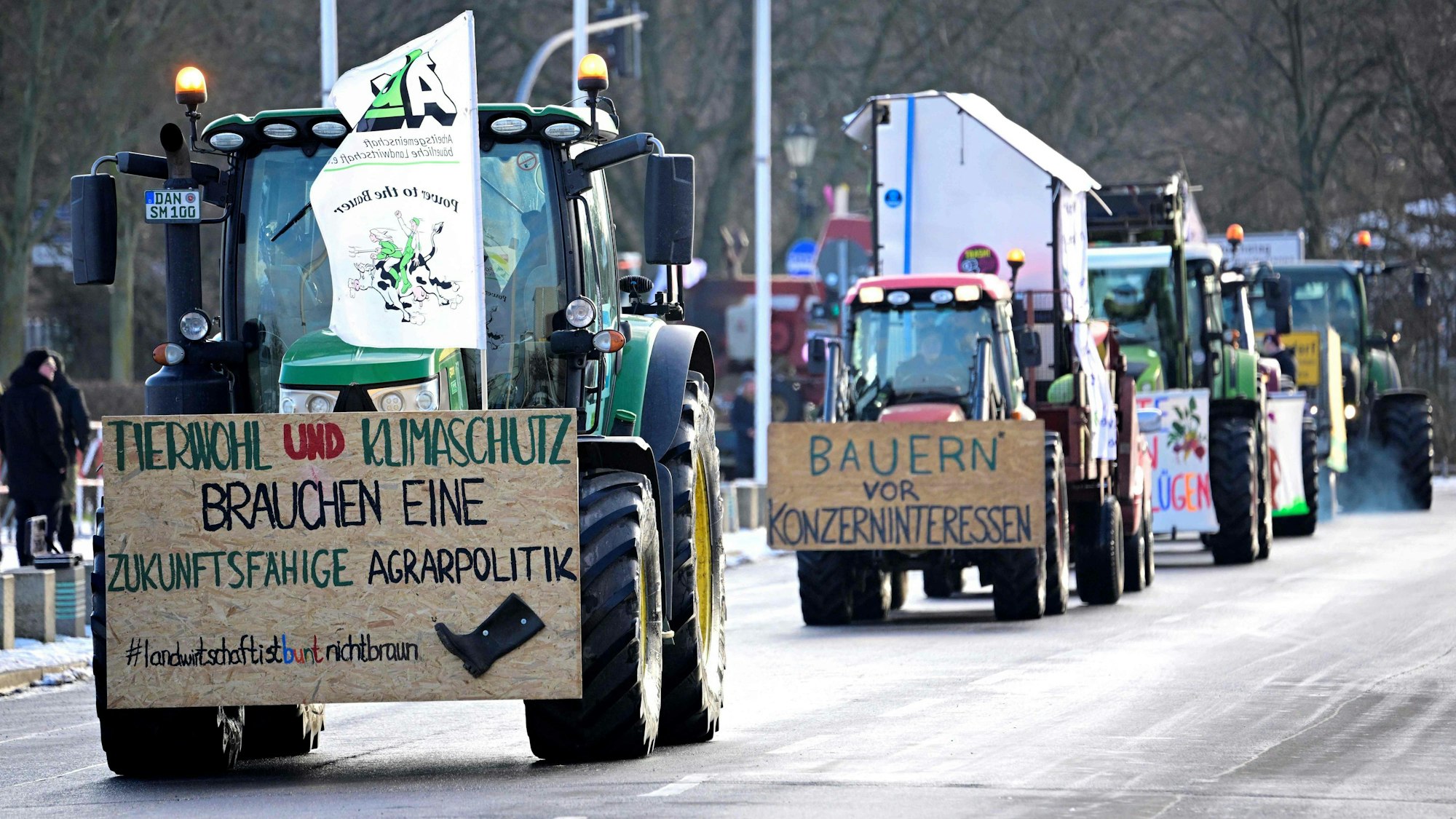 Farmers with their tractors drive near the Reichstag building during a protest under the title 'We are fed up with agricultural industry' against industrial food production in Berlin, Germany on January 20, 2024. The lettering on the board left reads 'Animal welfare and climate protection need a sustainable agricultural policy'. The demonstration started on January 20 in front of the headquarters of German Social Democratic Party SPD and ended with a rally in front of the Chancellery. (Photo by Tobias SCHWARZ / AFP)