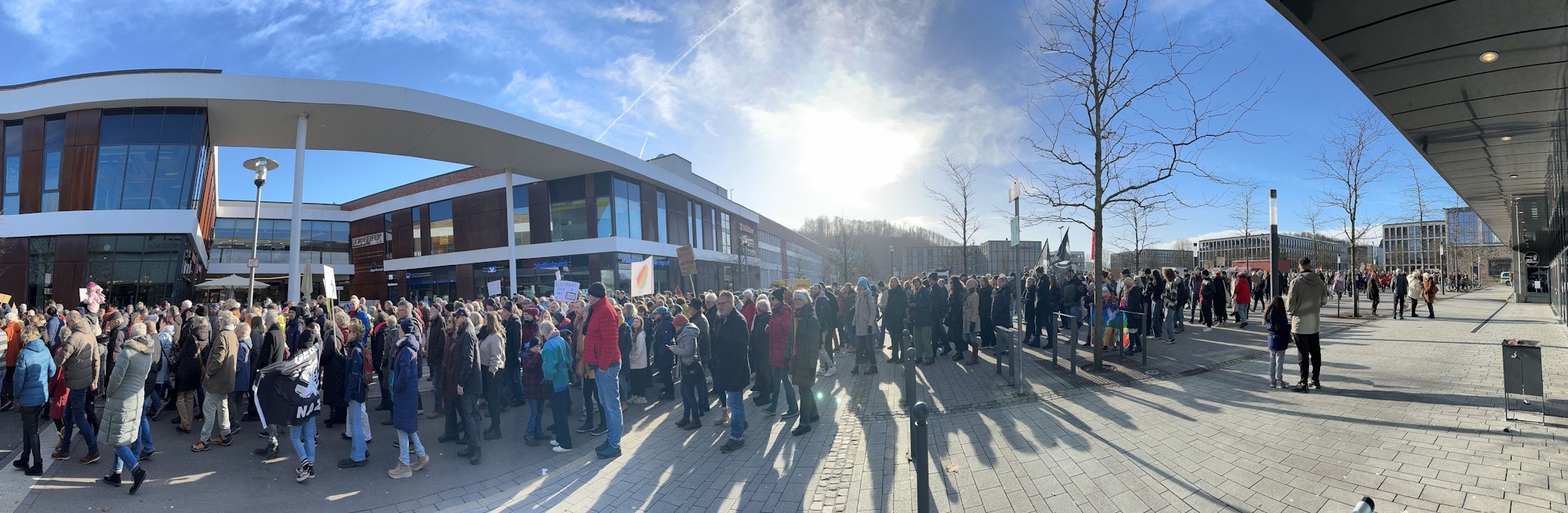 Menschen gehen in einer langen Schlange über die Straße.