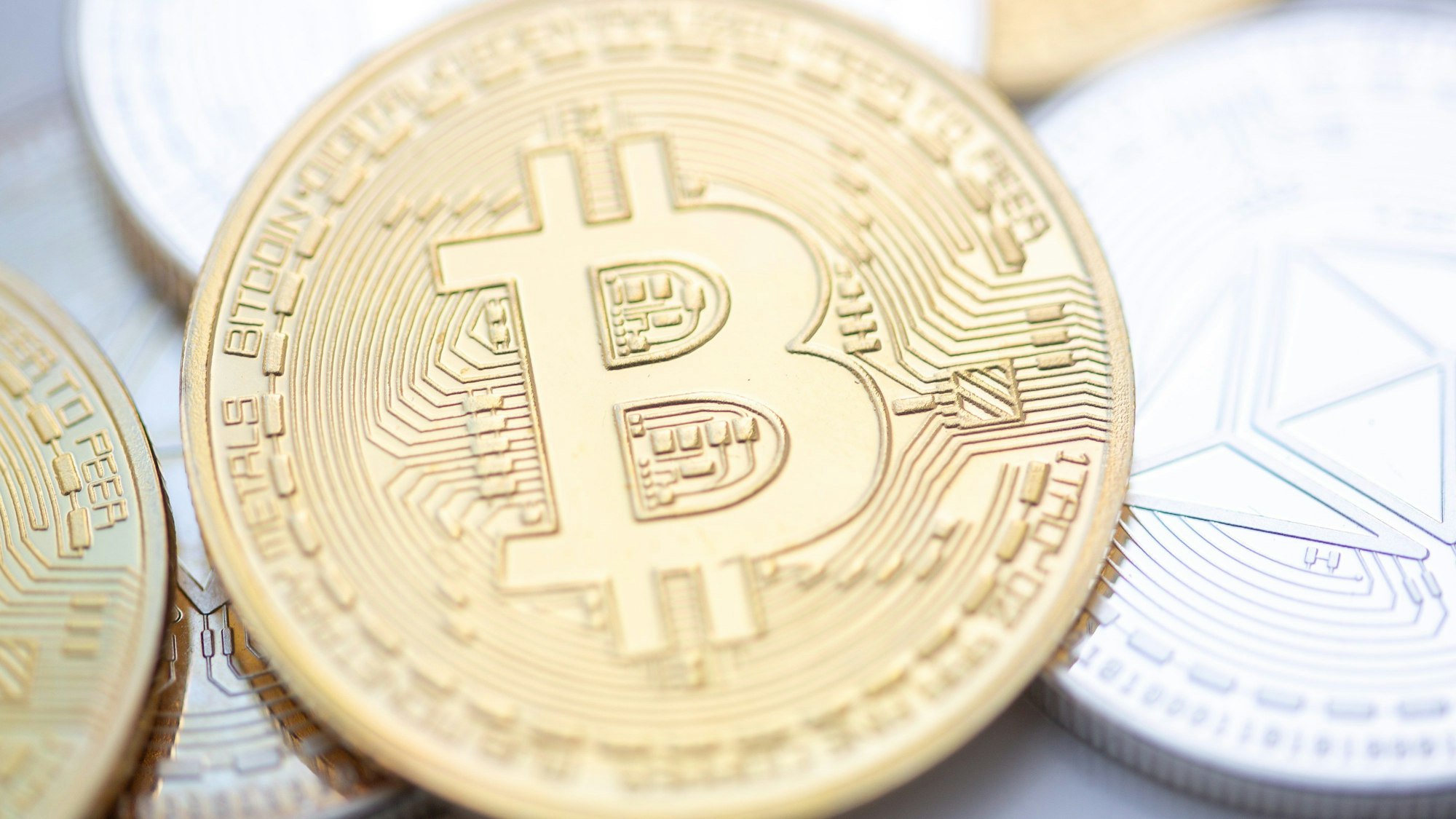 Eine geprägte Bitcoin-Münze liegt auf einem Tisch, sie repräsentiert die digitale Krypto-Währung. In Sachsen haben zwei mutmaßliche Betreiber einer illegalen Streaming-Plattform die bislang größte Bitcoin-Menge an Behörden übergeben.