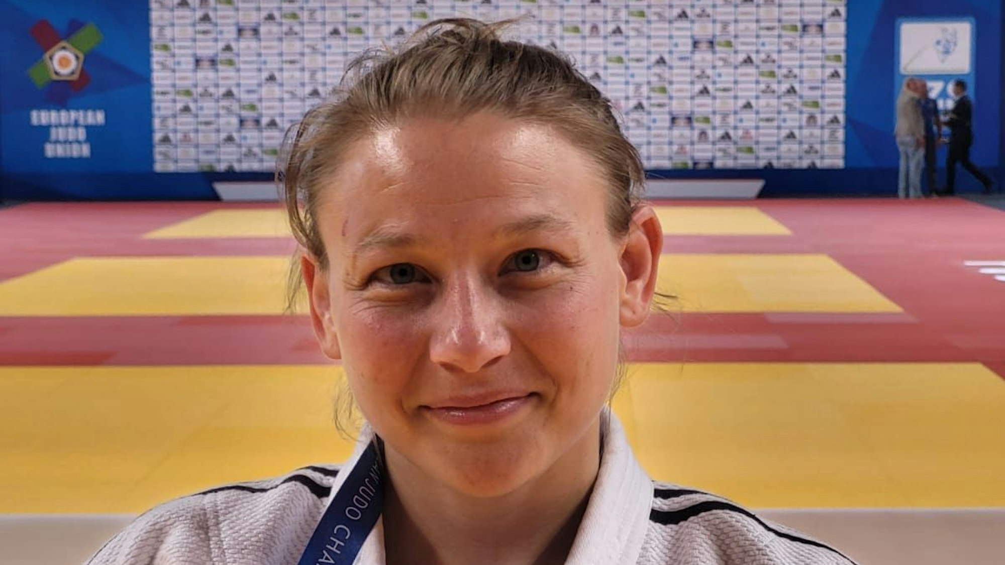 Das Bild zeigt Judoka Swantje Kaiser in einer Turnhalle, im Hintergrund sind Kampfmatten zu sehen.