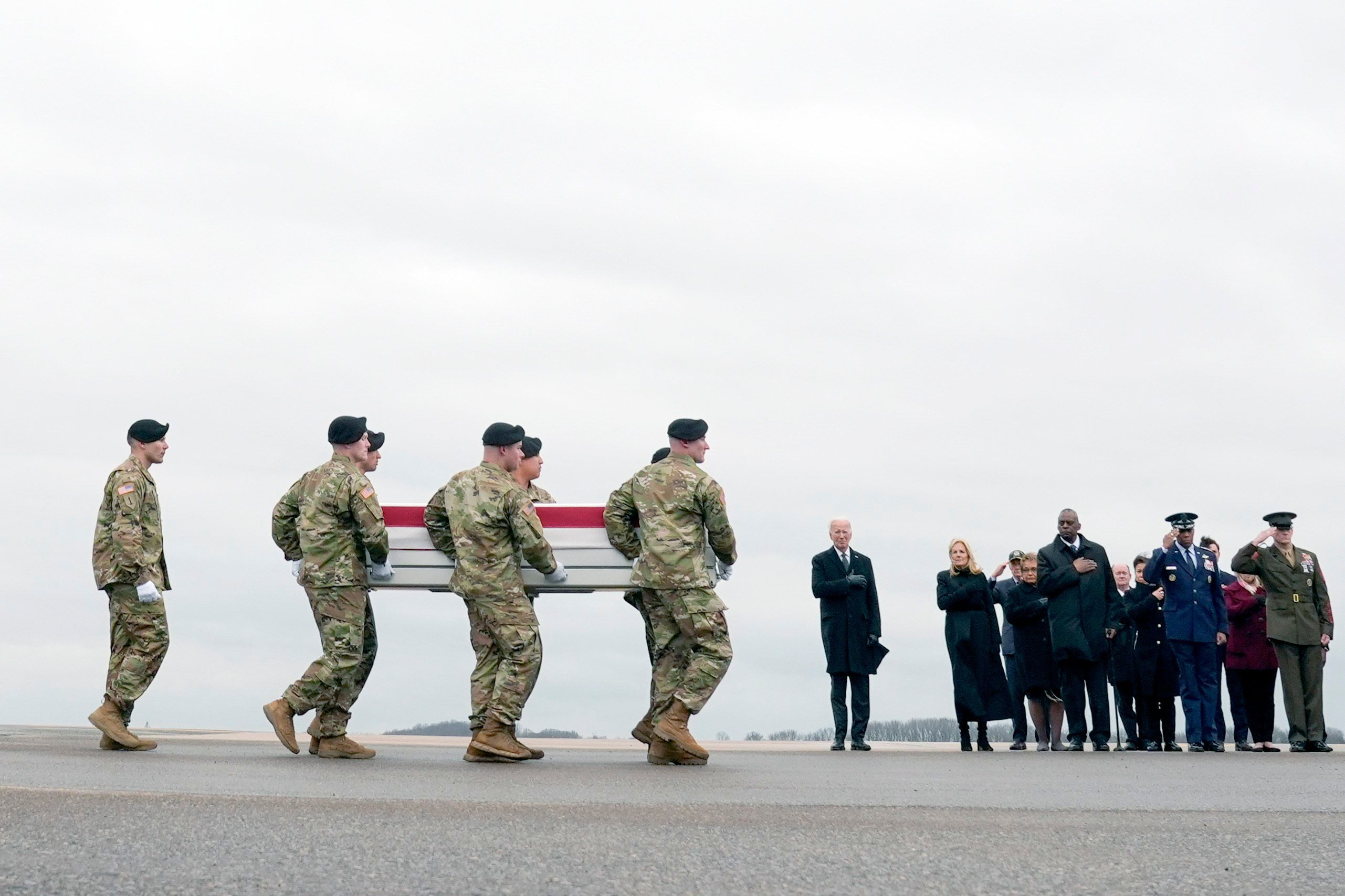 Joe Biden (M), Präsident der USA, und die First Lady Jill Biden (M.r.) sehen zu, wie ein Armeeteam den Transportkoffer mit den sterblichen Überresten von U.S. Army Sgt. William Jerome Rivers, 46, aus Carrollton, Georgia, auf der Dover Air Force Base tragen.