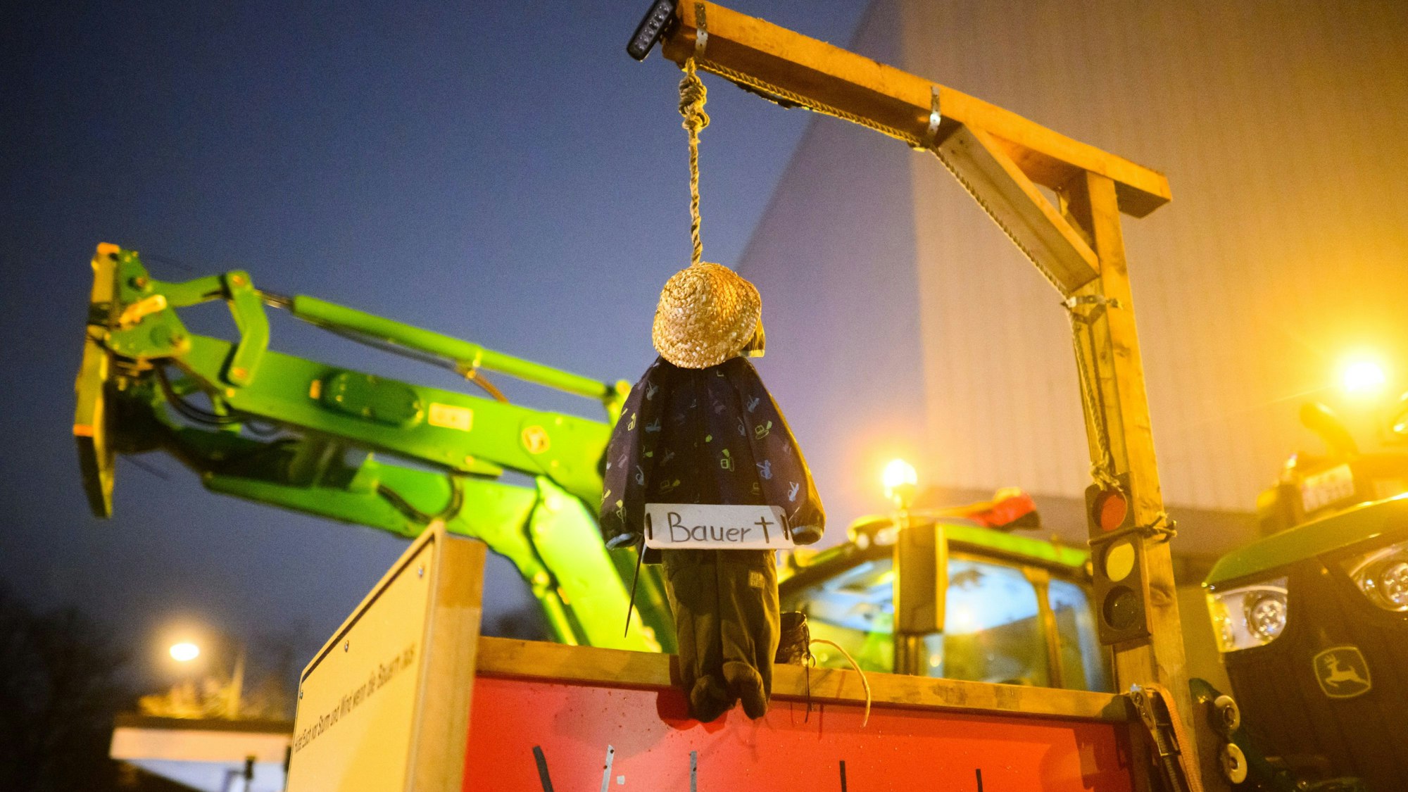 Protest vor dem NDR-Funkhaus in Hannover: Eine kleine Bauernpuppe hängt an einem Galgen mit Ampel-Symbol.