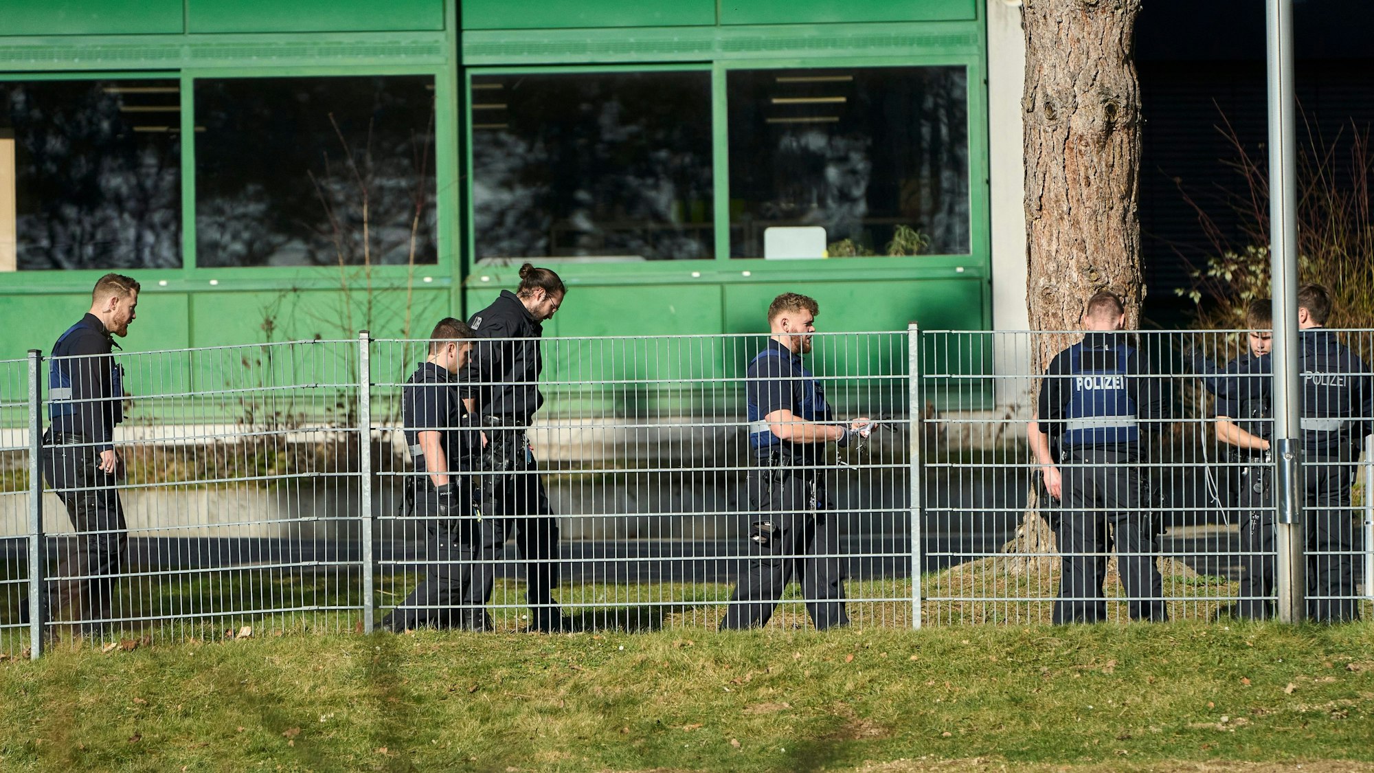 Polizisten durchsuchen das Gelände einer Schule in Neuwied.
