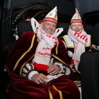 Prinz Andreas I. und Bauer Gerd vom Bergisch Gladbacher Dreigestirn sitzen auf der Rückbank des Dreigestirnsbusses.