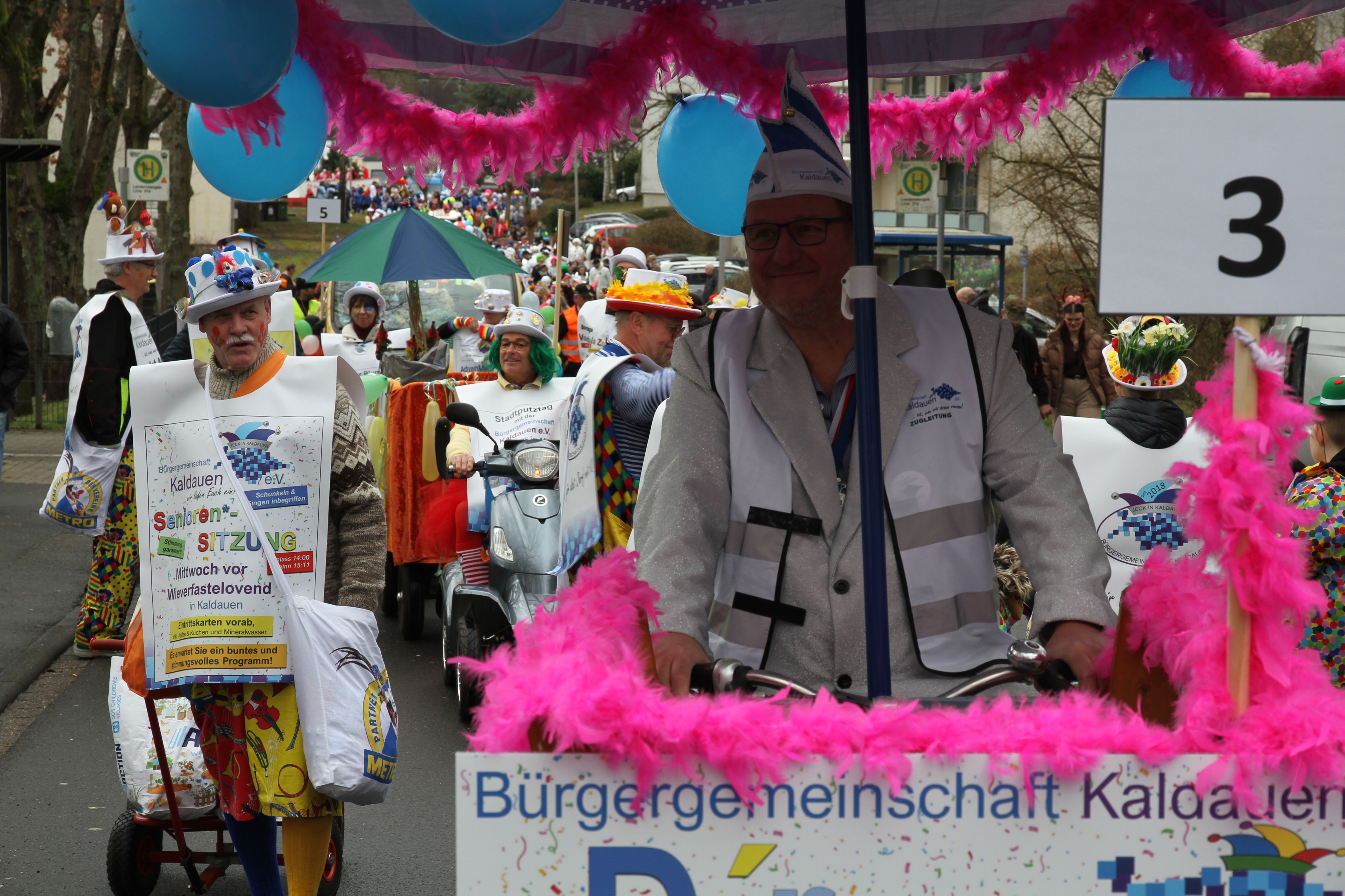 Blau-weiß kostümierte Jecke in einem Karnevalszug