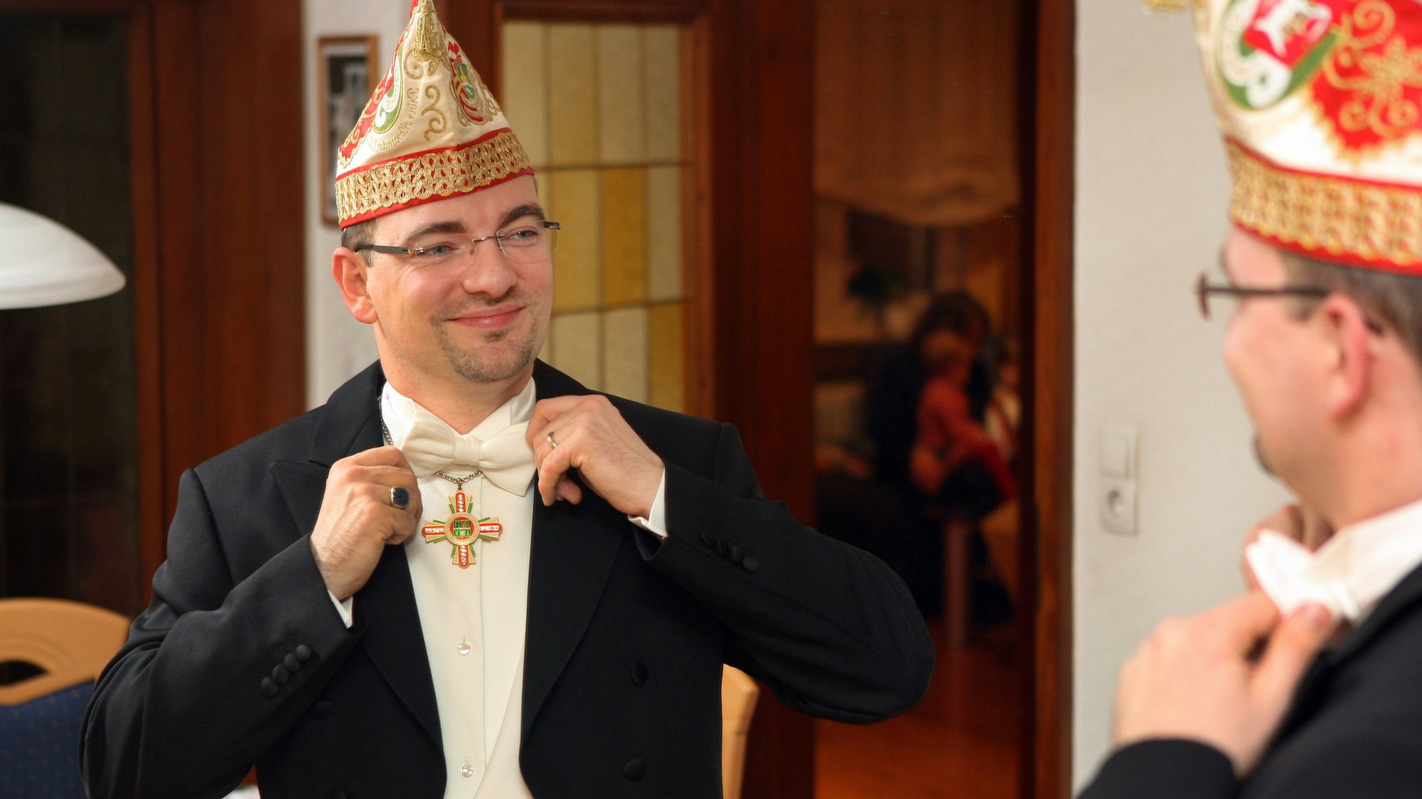 Alexander Pfister steht 2014 vor dem Spiegel und bindet seine Fliege.