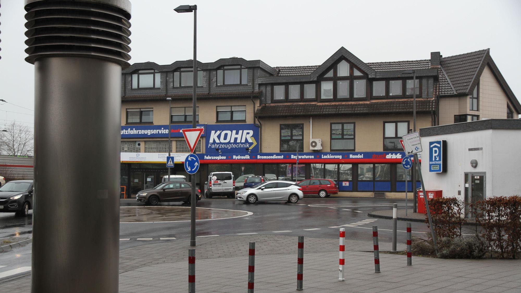 Ein Firmengebäude mit blauen Werbetafeln an einem Kreisverkehr