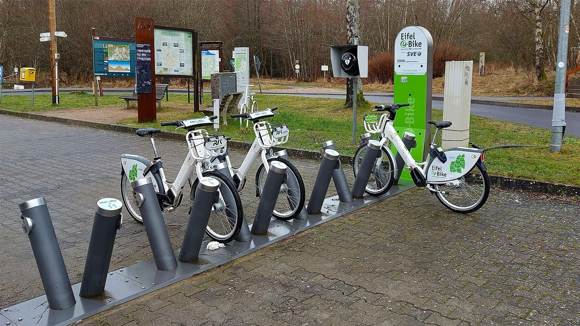 Vor dem Bahnhofsgebäude gibt es E-Bike-Verleih, dazu Ladestationen, touristische Hinweisschilder, Parkplätze und einen Briefkasten.