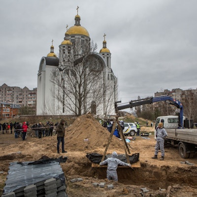 Forensic technicians exhume the bodies of civilians who Ukrainian officials say were killed during Russia’s invasion and then buried in a mass grave in the town of Bucha, outside Kyiv, Ukraine April 13, 2022. REUTERS/Volodymyr Petrov