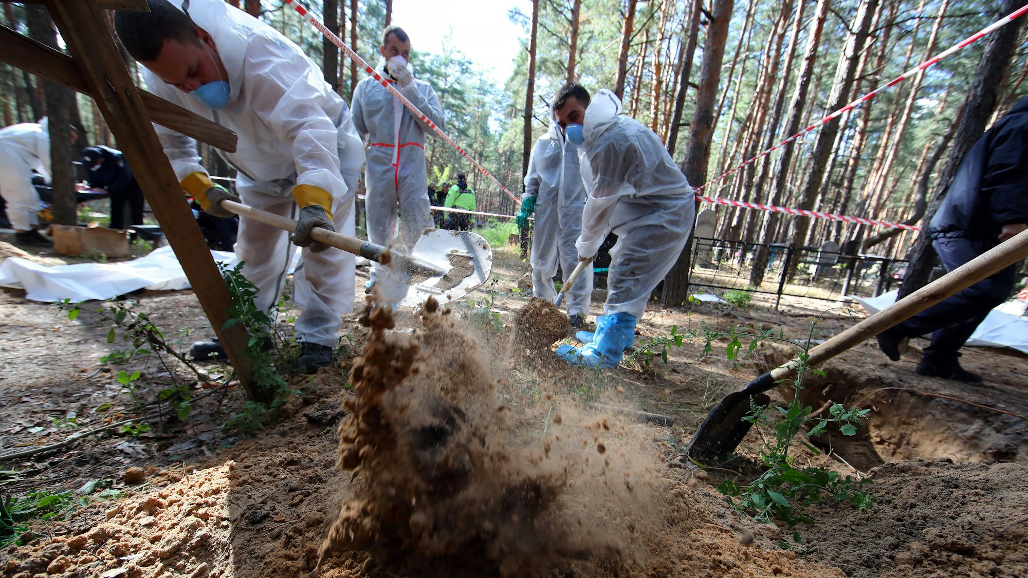 Nach der Befreiung der ukrainischen Stadt Isjum öffnen Helfer die Gräber von Opfern, die im Wald verscharrt wurden.