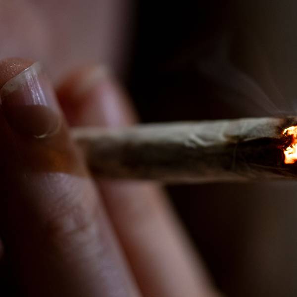 Eine Person raucht einen Joint.