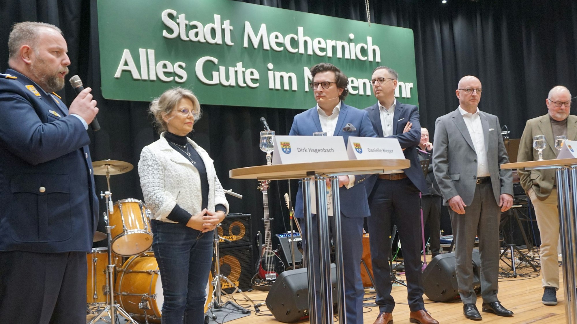 Auf der Bühne stehen sechs Personen. Im Hintergrund hängt ein Schild. Darauf steht: „Stadt Mechernich: Alles Gute im Neuen Jahr“