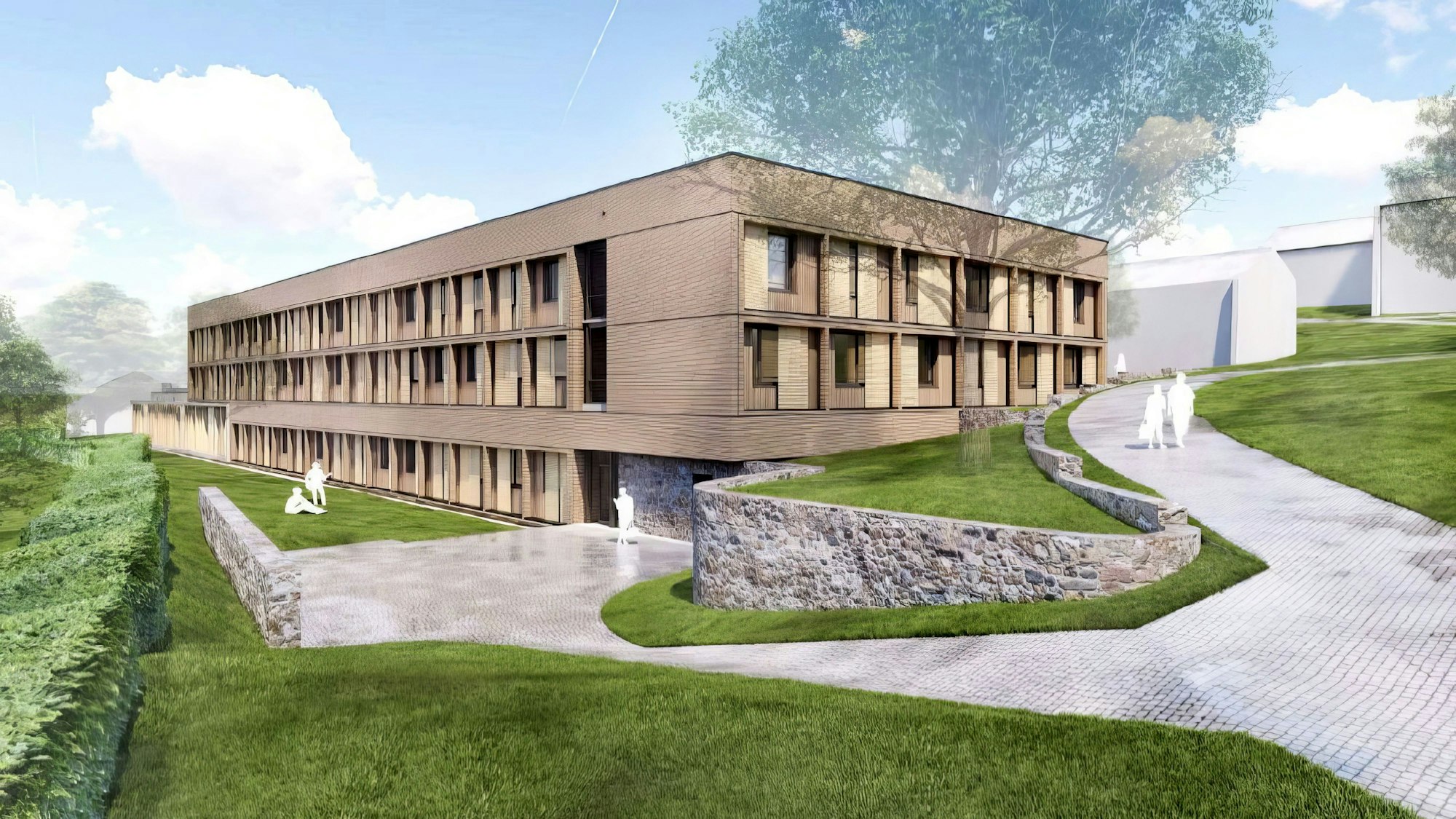 Ein langgestreckter Bau aus Holz ist umgeben von Fußwegen und einer Grünanlage.