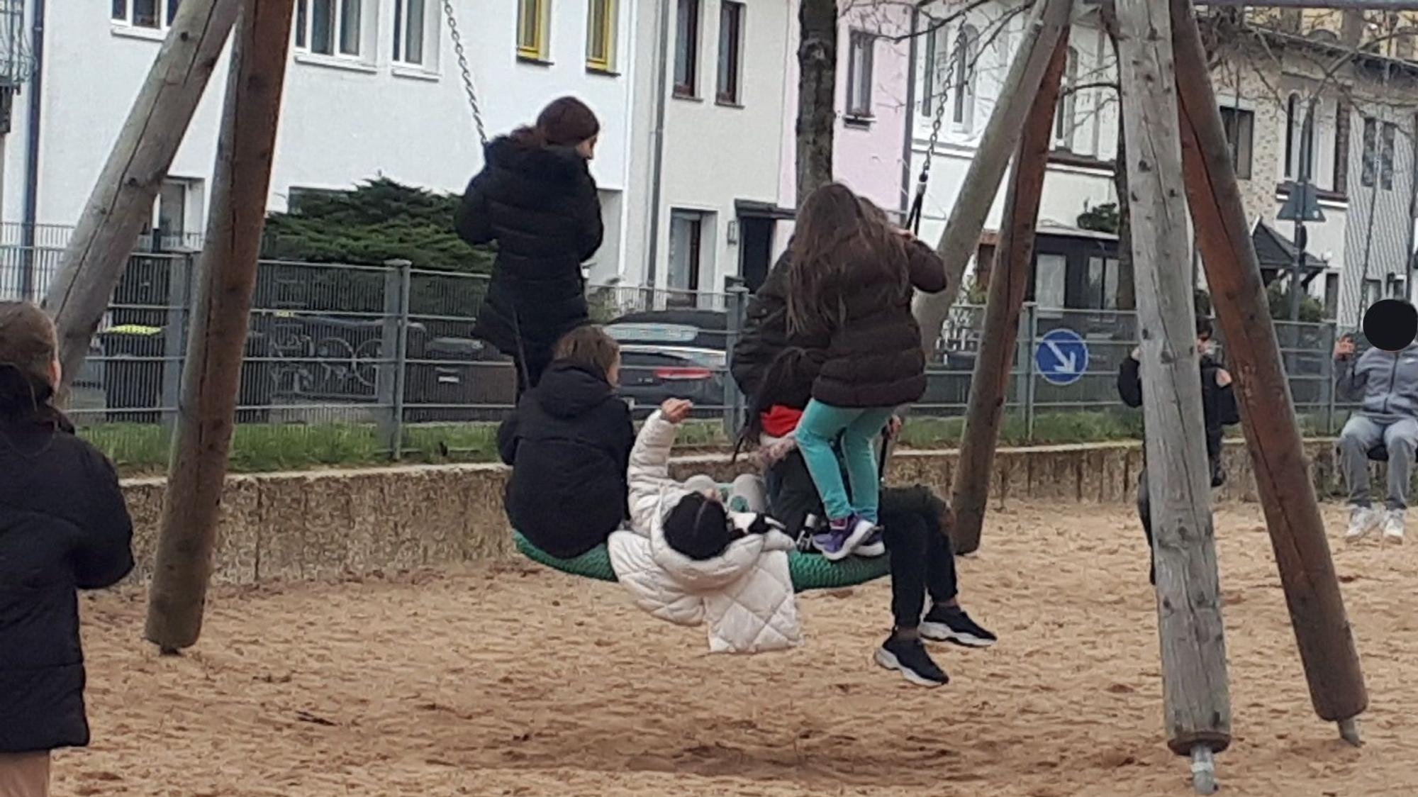 Kinder auf einer Nestschaukel