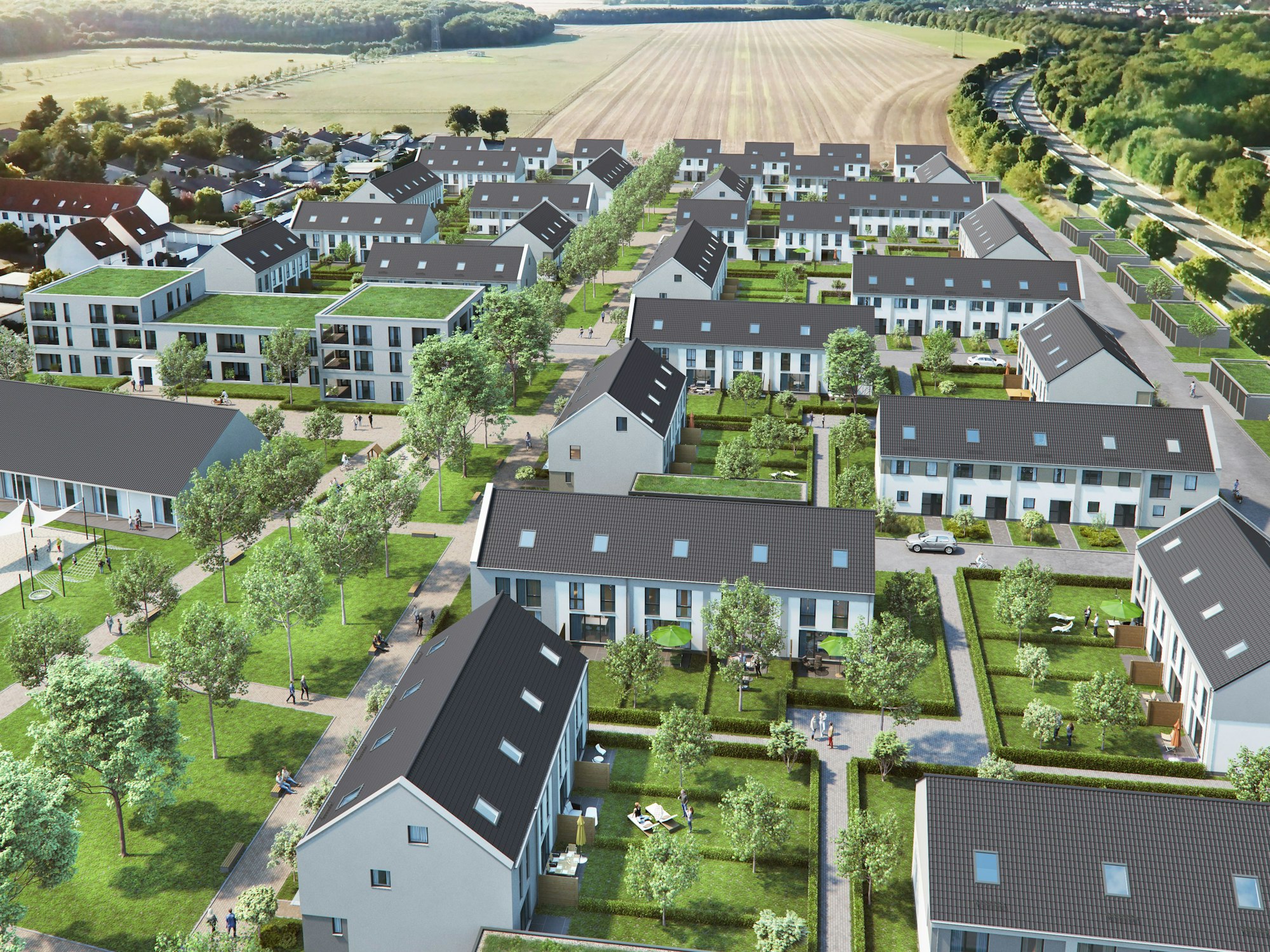 Blick auf eine Reihenhaussiedlung am Rande eines Ackers