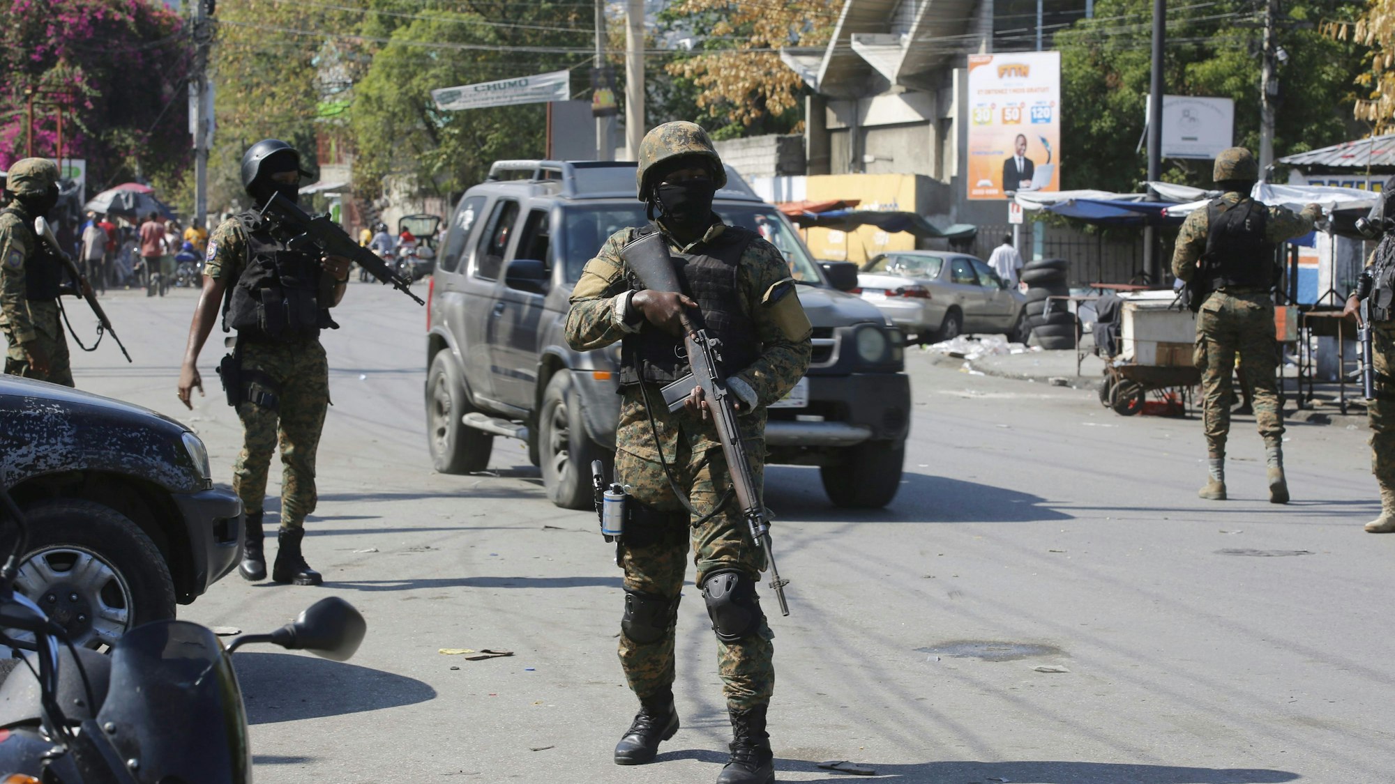 09.03.2024, Haiti, Port-au-Prince: Mitglieder der Allgemeinen Sicherheitseinheit des Nationalen Palastes (USGPN) errichten eine Sicherheitsabsperrung um einen der drei Bahnhöfe im Stadtzentrum, nachdem die Polizei am Vortag einen Angriff von Banden abgewehrt hat.