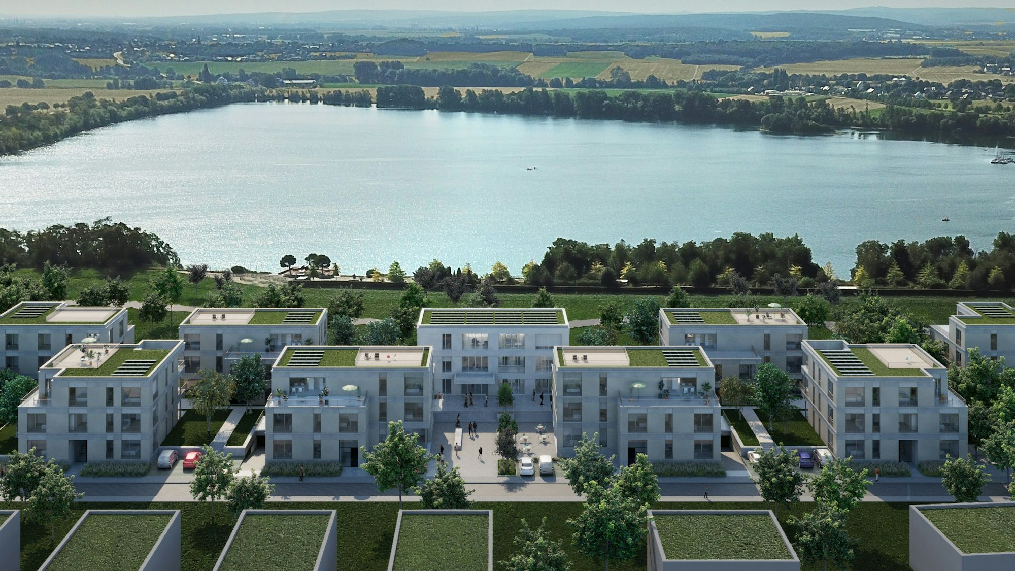 Eine Visualisierung zeigt mehrere helle Gebäude mit Gründächern vor der Kulisse des Zülpicher Wassersportsees.