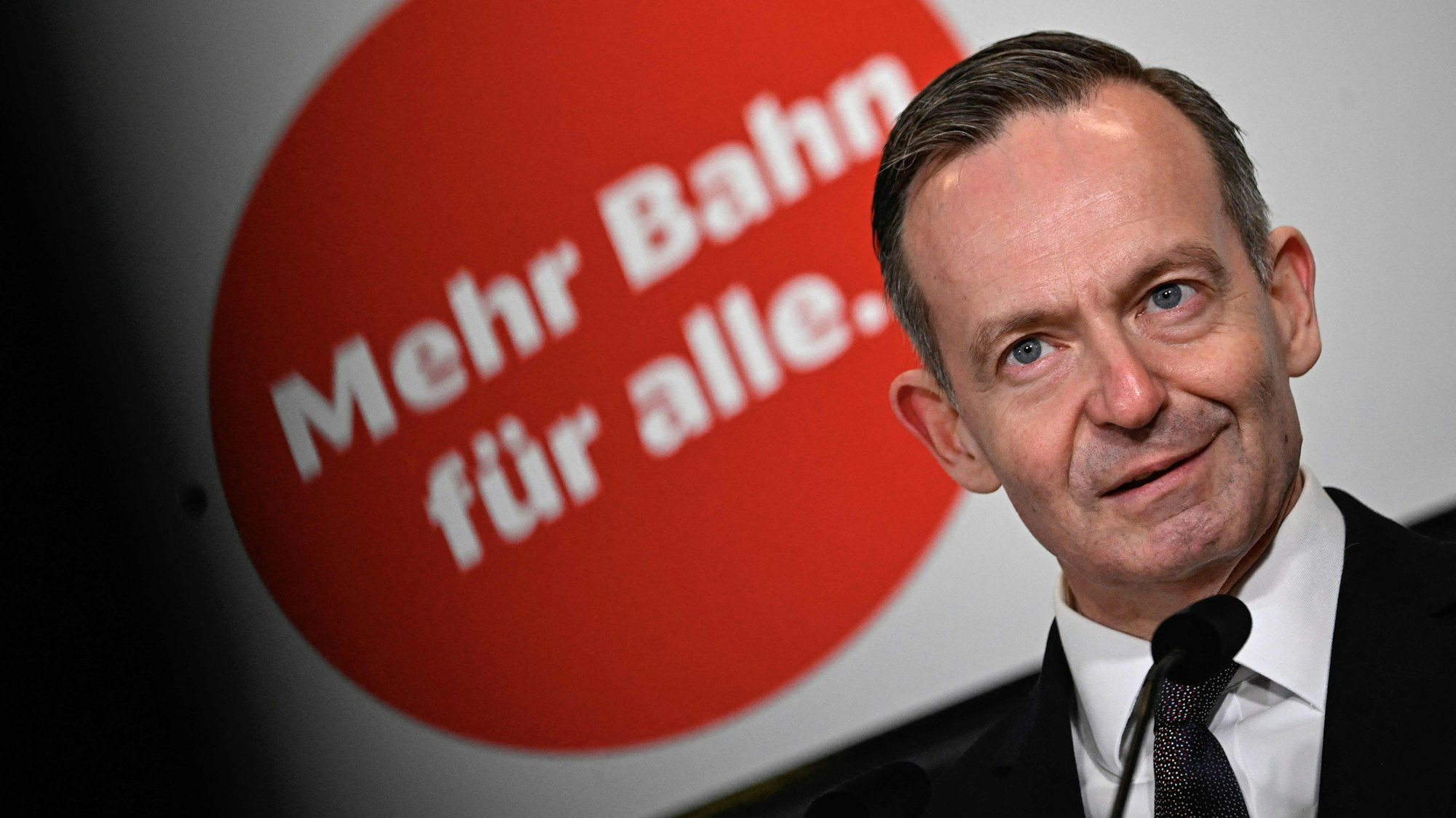 German Minister for Transport and Digital Affairs Volker Wissing talks in front of an inscription reading "More Railway for all" during the christening of highspeed ICE 4 train "Spree" at Berlin's main station (Hauptbahnhof) on March 18, 2024 in Berlin. The 137th and final ICE 4 long-distance Intercity-Express high-speed train constructed by Siemens was recently delivered to Deutsche Bahn. According to German railway operator, it's "the largest procurement project in the history of the DB". (Photo by Tobias SCHWARZ / AFP)