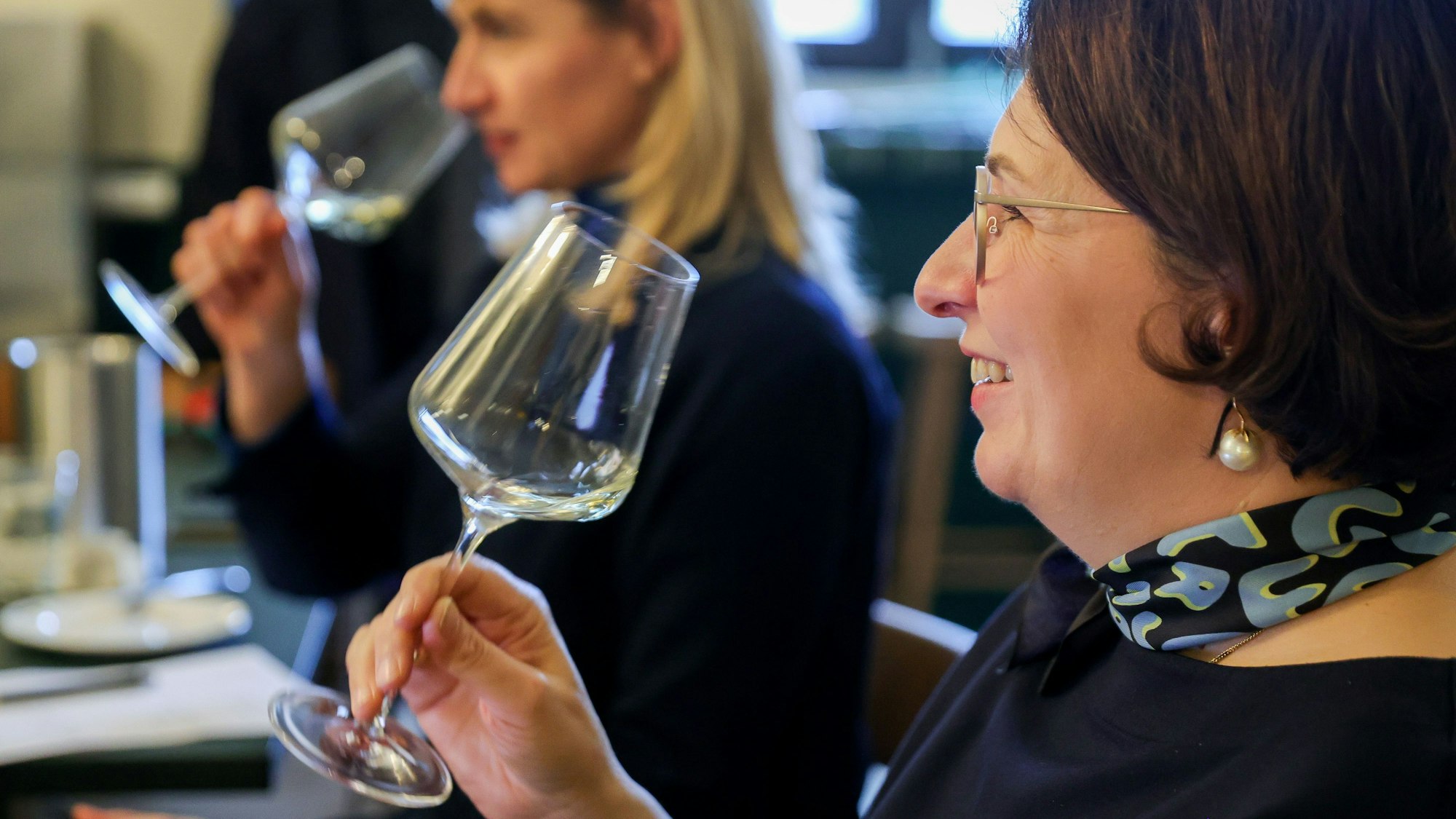 Romana Echensperger hält ein Glas Wein in der Hand
