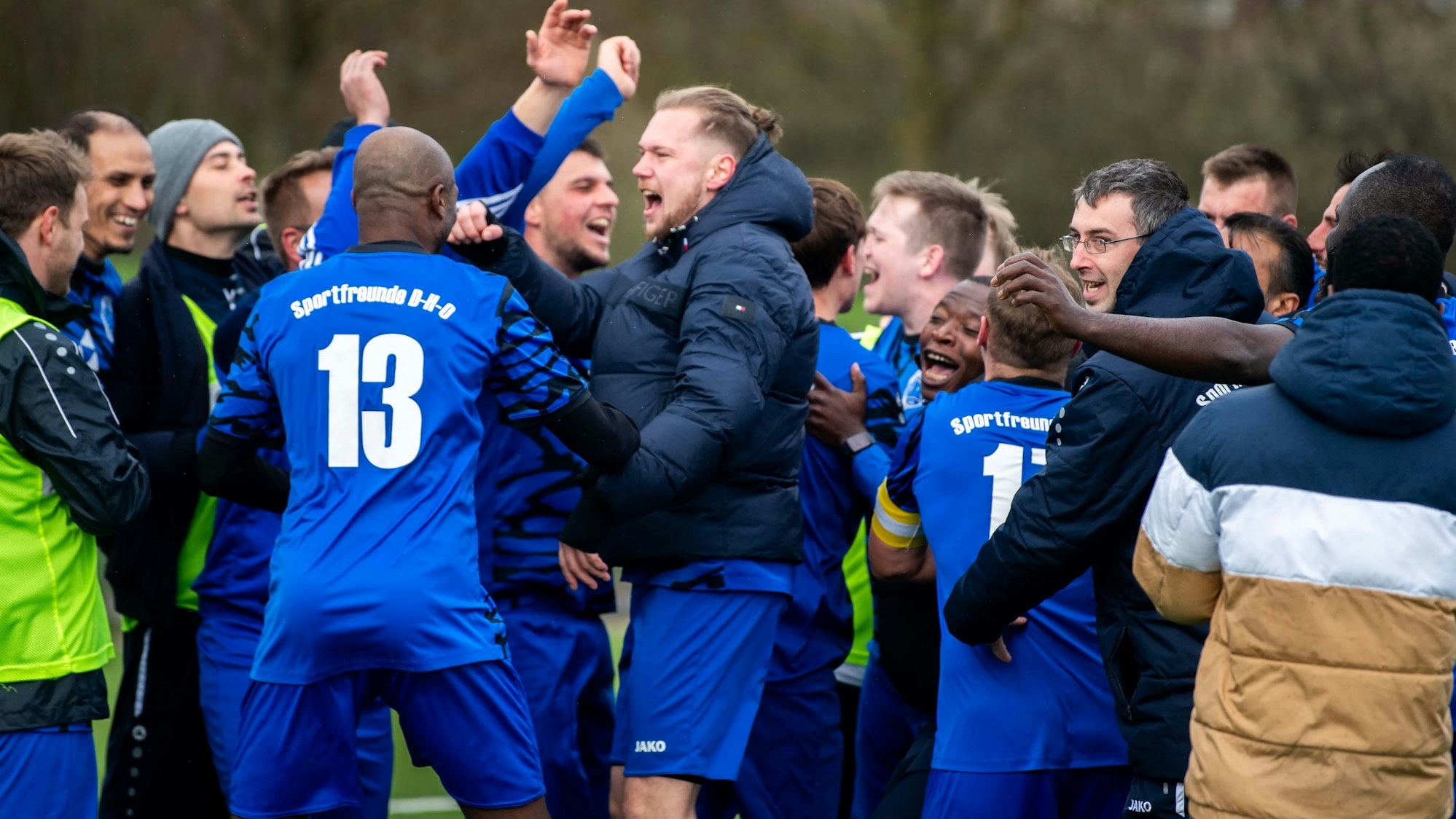 Das Bild zeigt die Spieler der Sportfreunde nach dem Schlusspfiff. Sie jubeln.