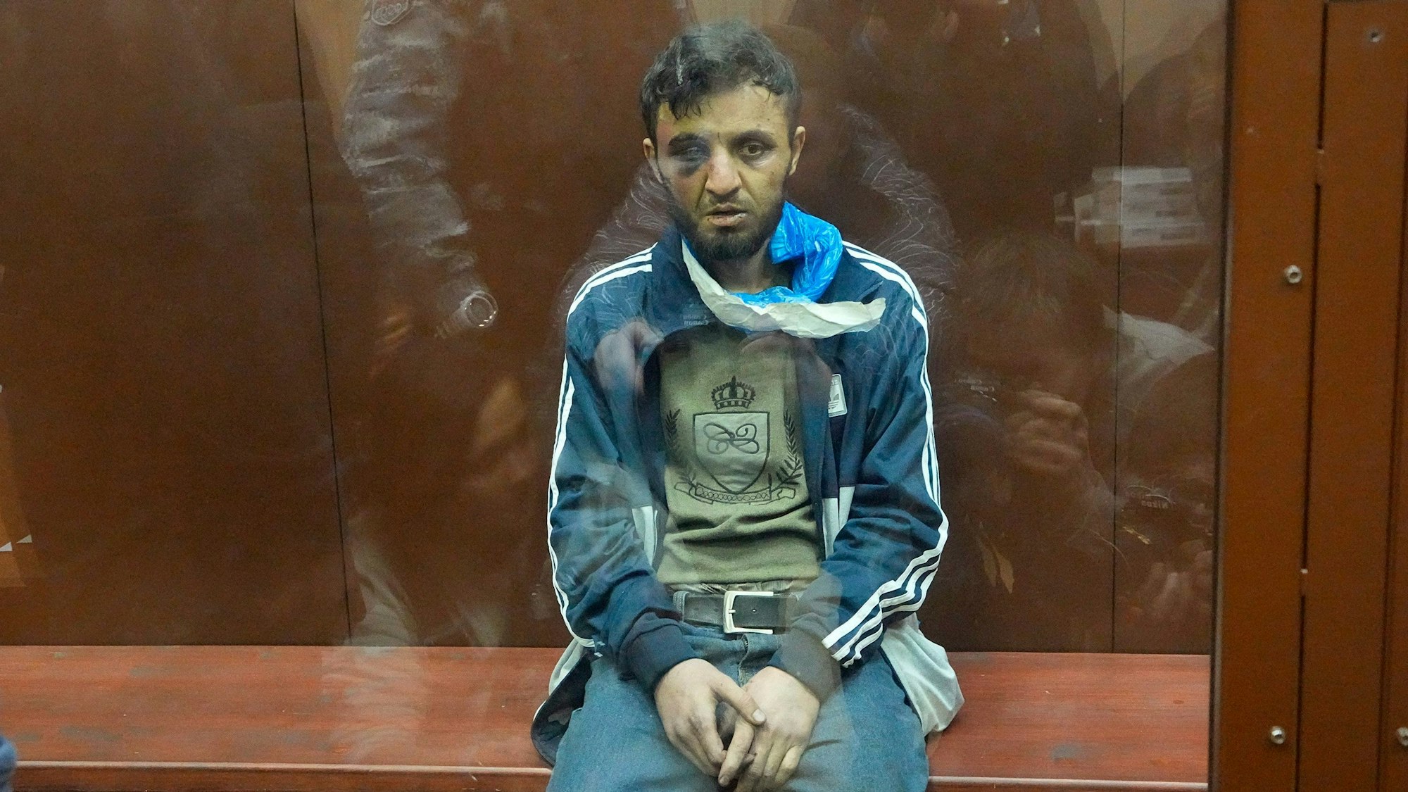 24.03.2024, Russland, Moskau: Ein Tatverdächtiger des Terroranschlags auf die Konzerthalle Crocus City Hall sitzt in einem Glaskäfig im Bezirksgericht Basmanny. Ein Gericht in Moskau hat am Sonntagabend die ersten Haftbefehle gegen mutmaßliche Akteure des blutigen Terroranschlags auf eine Konzerthalle nordwestlich der russischen Hauptstadt erlassen. Foto: Alexander Zemlianichenko/AP/dpa +++ dpa-Bildfunk +++