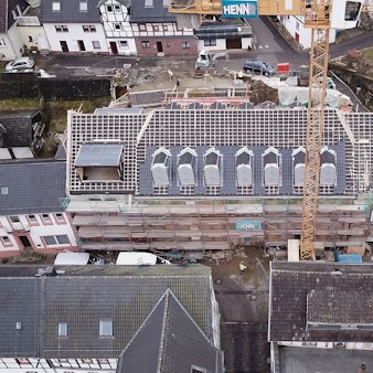 Das Luftbild zeigt das historische Gebäude an der Blankenheimer Ahrstraße. Das Haus ist eingerüstet, das Dach ist abgedeckt.