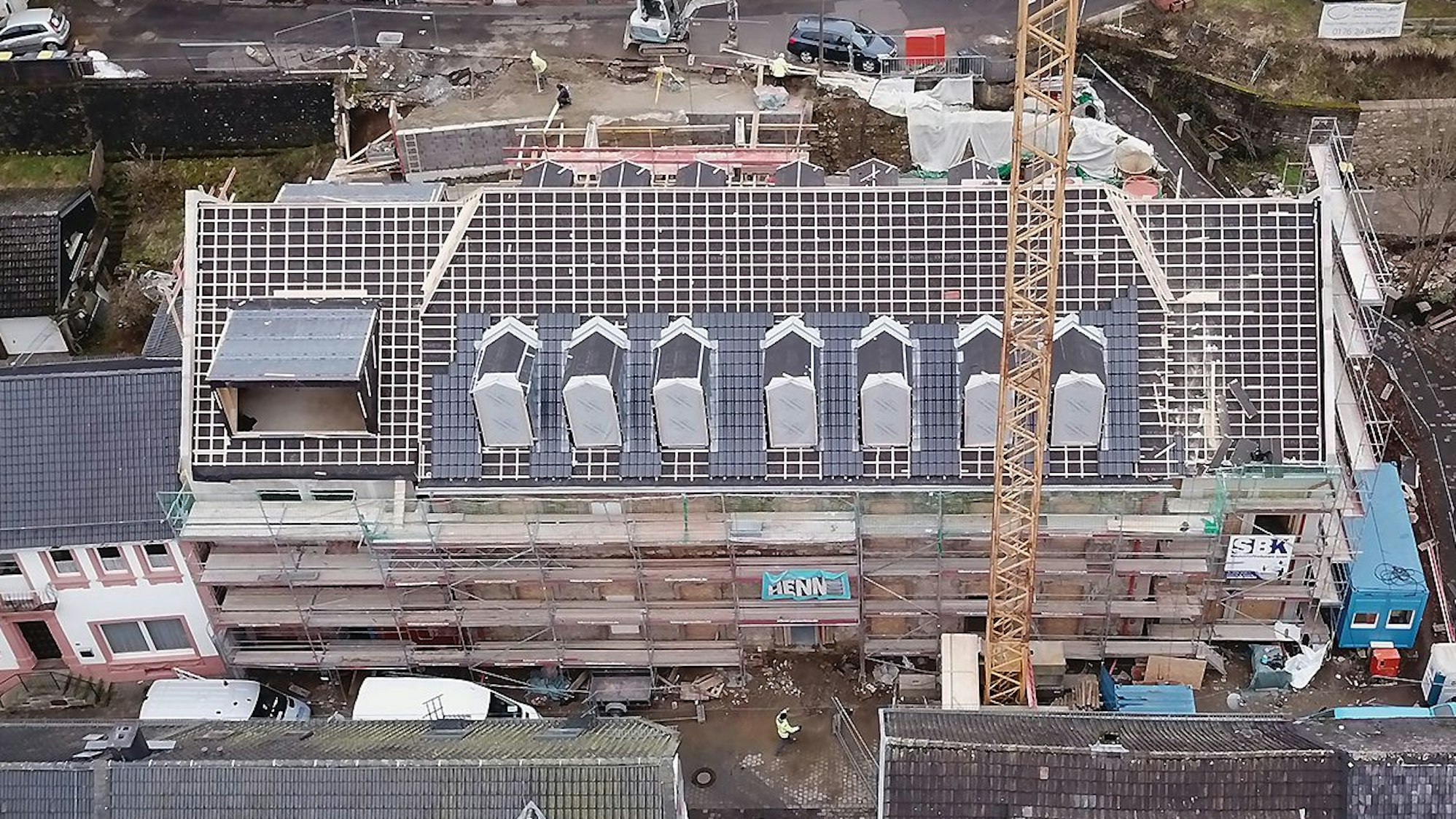 Das Luftbild zeigt das historische Gebäude an der Blankenheimer Ahrstraße. Das Haus ist eingerüstet, das Dach ist abgedeckt.