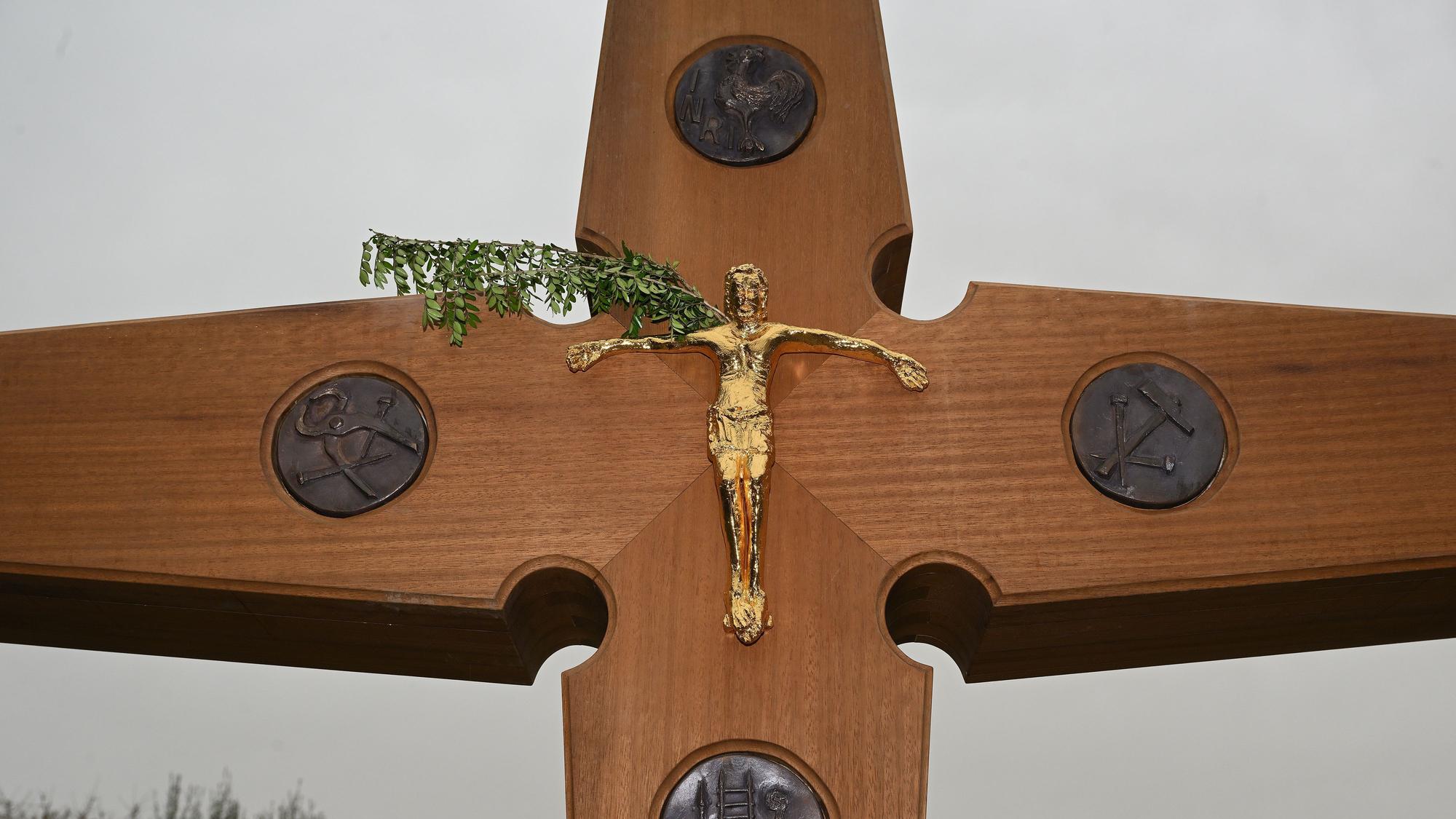 Das Wegekreuz zeigt eine vergoldete Christusdarstellung.