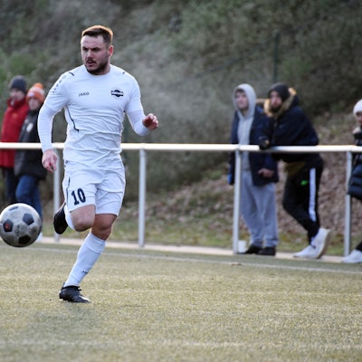 Ömer Tokac hat sich den Ball vorgelegt und läuft über das Spielfeld.