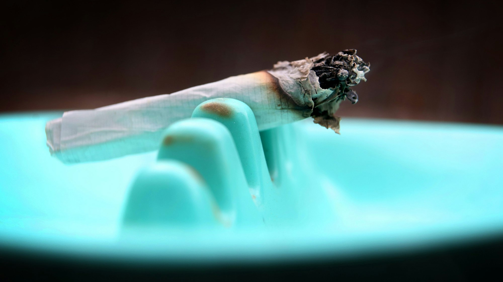 Ein Joint klemmt in einem Aschenbecher.