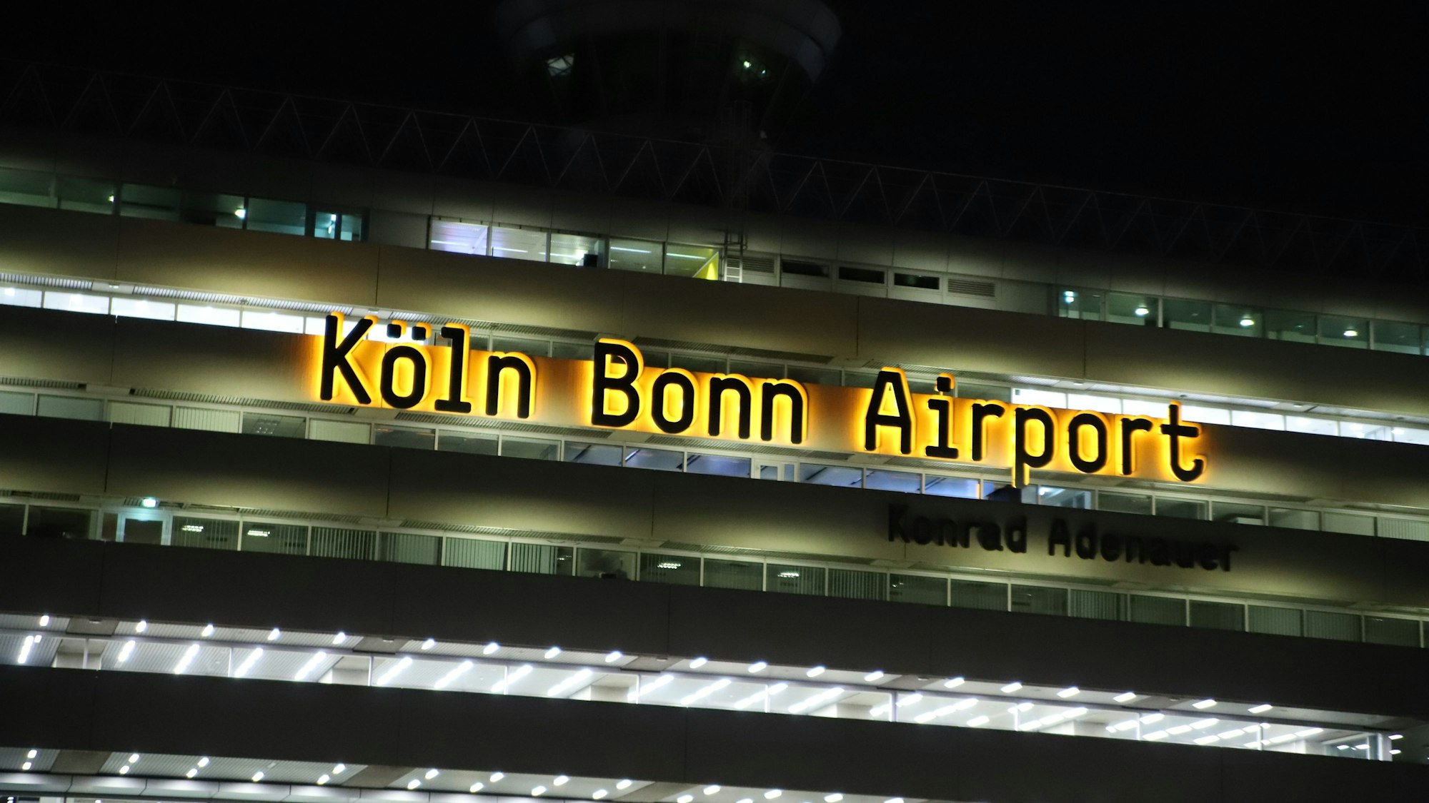 Das Logo Köln Bonn Airport leuchtet am Terminalgebäude des Flughafens Köln/Bonn.