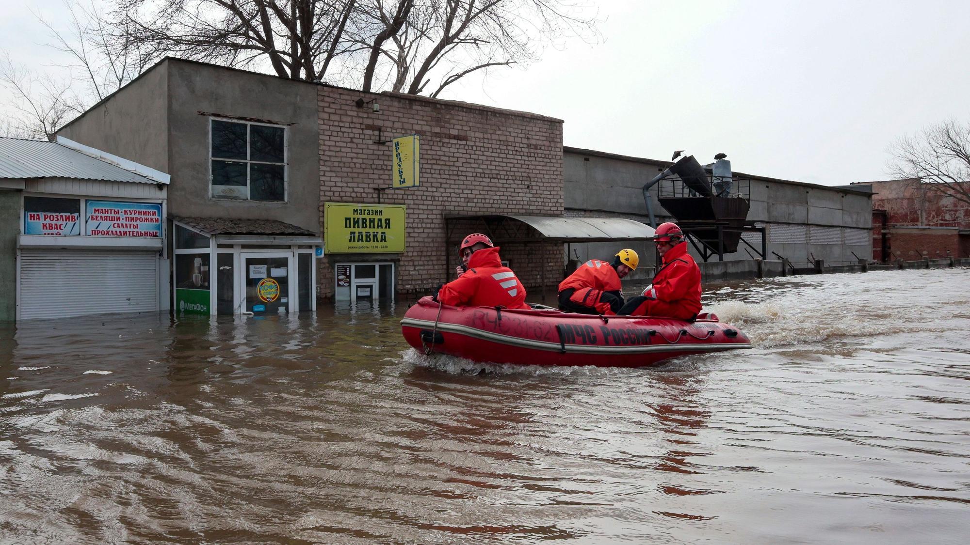Russian Emergency Ministry employees ride a boat as they patrol the flooded street in Orenburg, Russia, Friday, April 12, 2024. Floods have sparked evacuations of thousands in the Orenburg region, located some 1,200 kilometers (745 miles), southeast of the capital of Moscow after a dam on the river burst last week under the pressure of surging waters. Local authorities have declared a state of emergency in the region. (AP Photo)