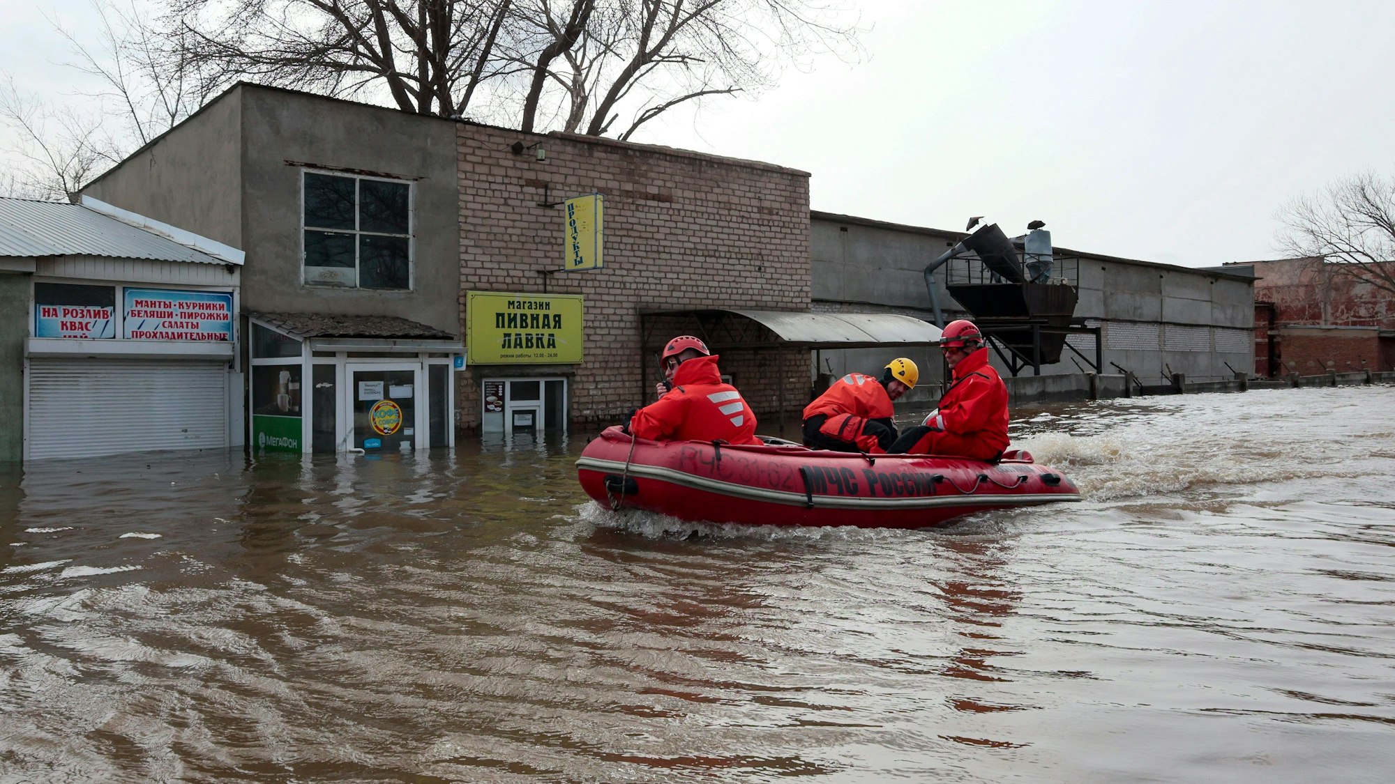 Russian Emergency Ministry employees ride a boat as they patrol the flooded street in Orenburg, Russia, Friday, April 12, 2024. Floods have sparked evacuations of thousands in the Orenburg region, located some 1,200 kilometers (745 miles), southeast of the capital of Moscow after a dam on the river burst last week under the pressure of surging waters. Local authorities have declared a state of emergency in the region. (AP Photo)